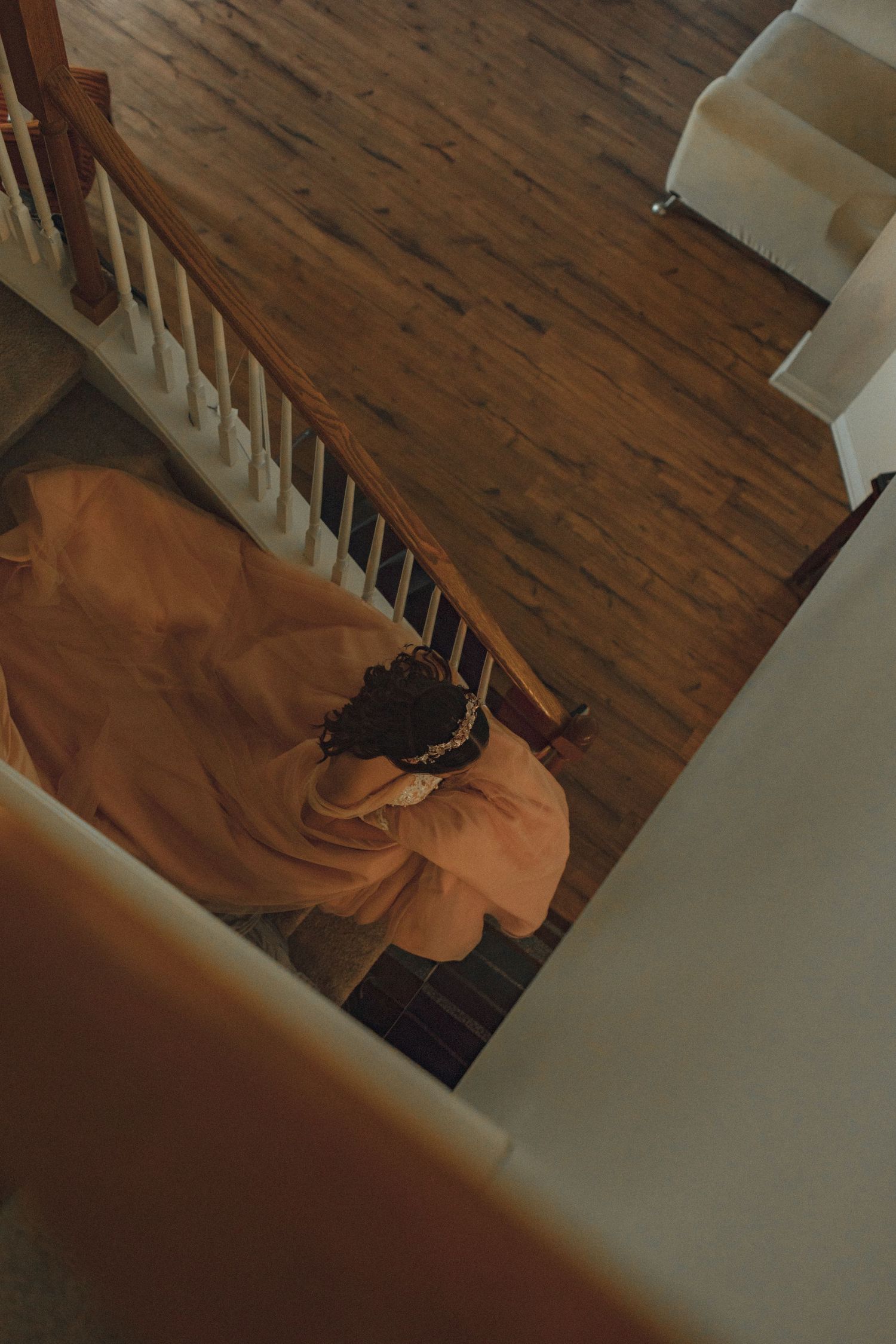 Person walking on rustic wooden floor in dimly lit interior space.