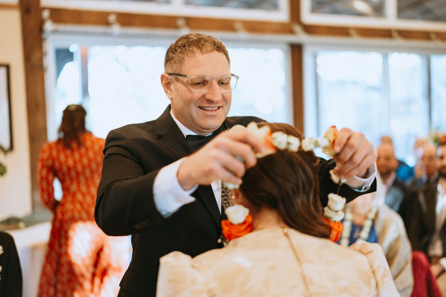 Wedding reception candid showing guests dancing and celebrating.