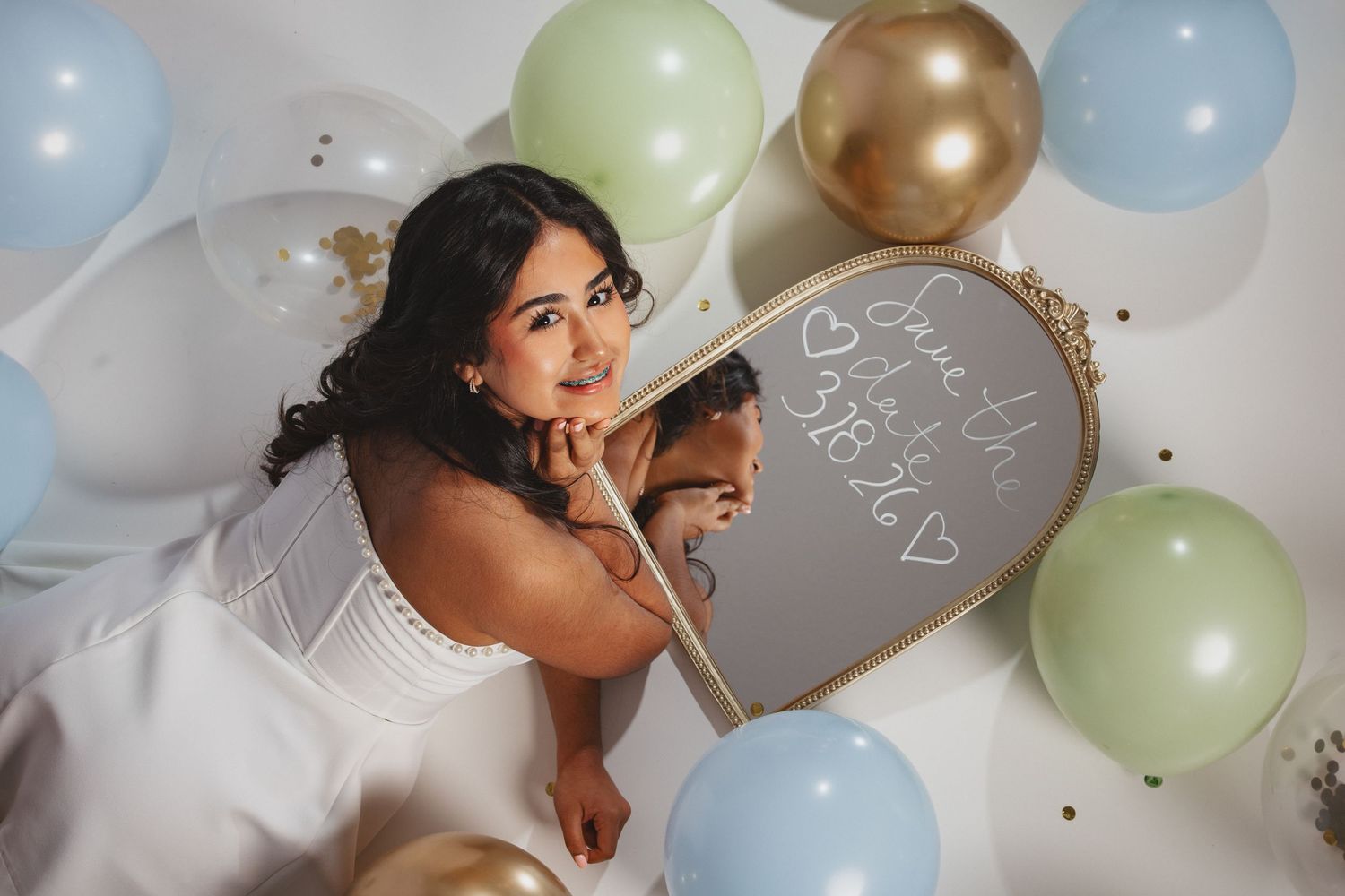 Celebratory quinceañera scene with pastel balloons and festive decorations.