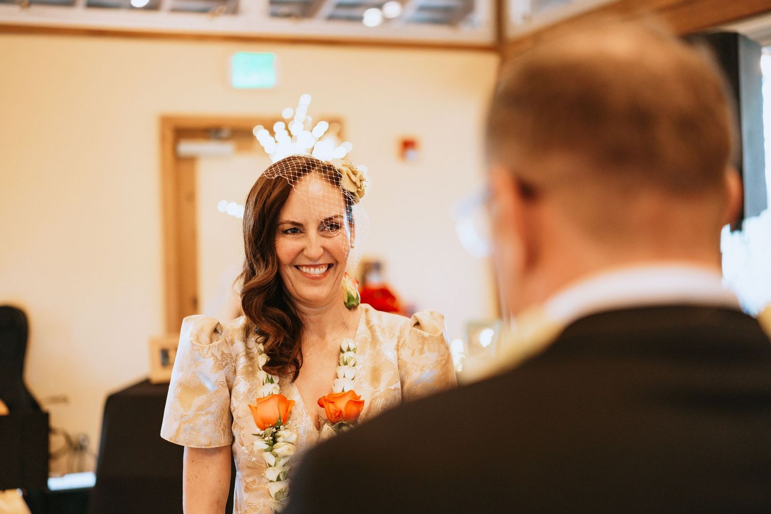 Candid moment captured during wedding reception with warm lighting.