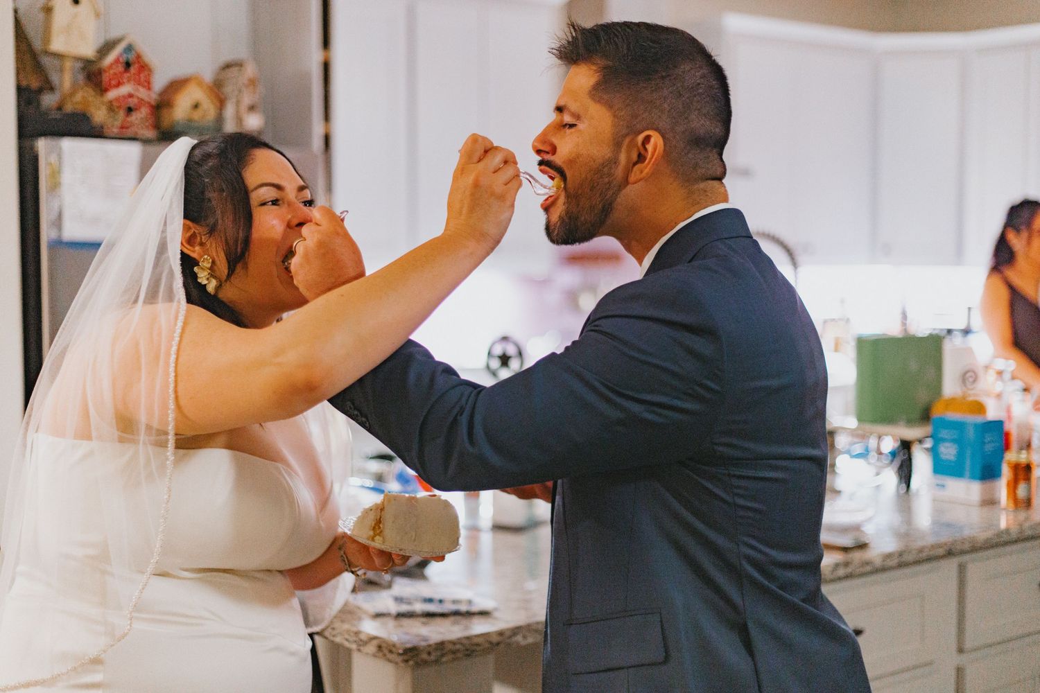 A couple dances together during their wedding celebration in an elegant indoor setting.