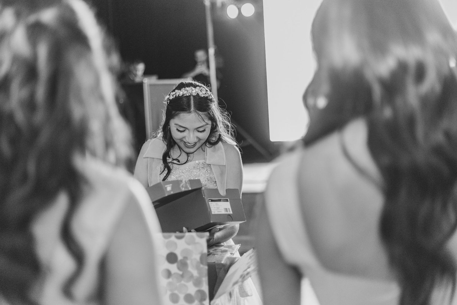 Black and white photo of a couple sharing their first dance at a wedding reception.
