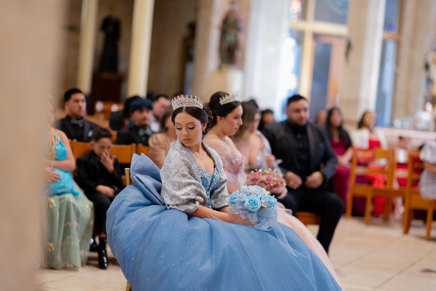 Formal celebration in church featuring blue ball gown and decorative interior.