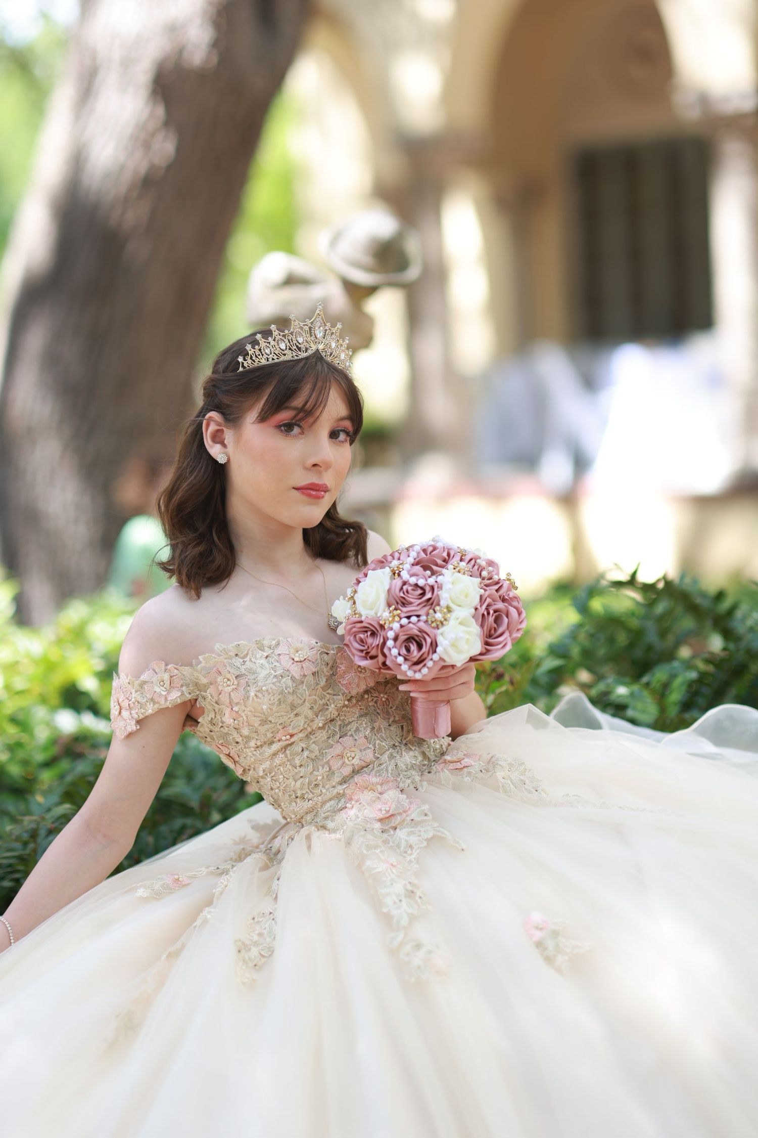 Dreamy bridal photoshoot in a white and gold ballgown with delicate floral details.