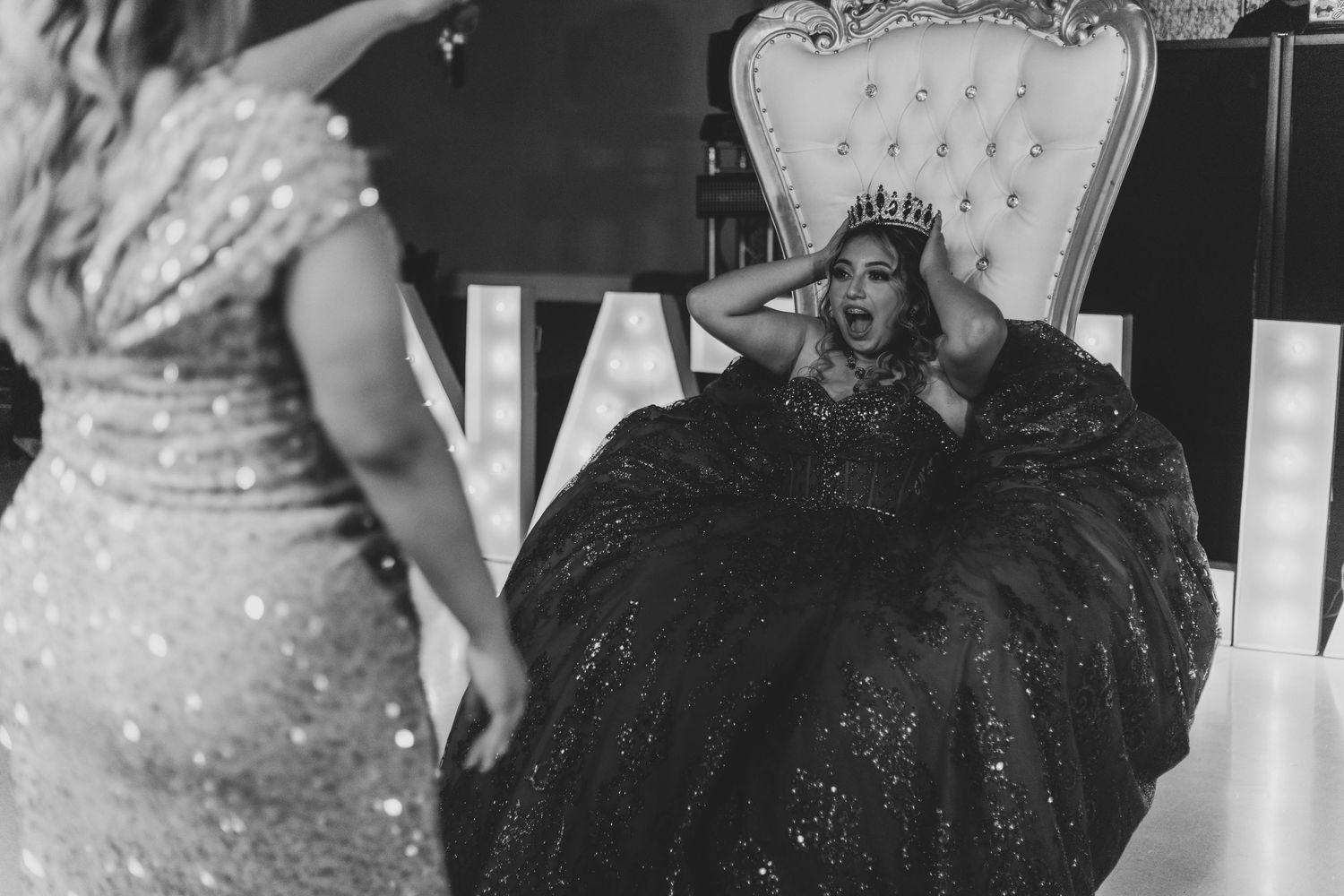Dramatic black and white photo of a formal event with an elegant gown.