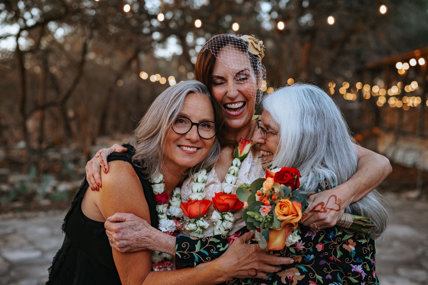 Intimate wedding moments captured outdoors with string lights and fall colors.