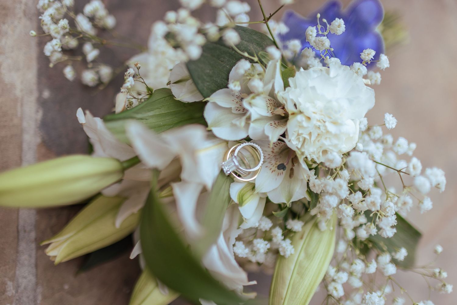Delicate white and purple floral wedding bouquet arrangements with baby's breath.