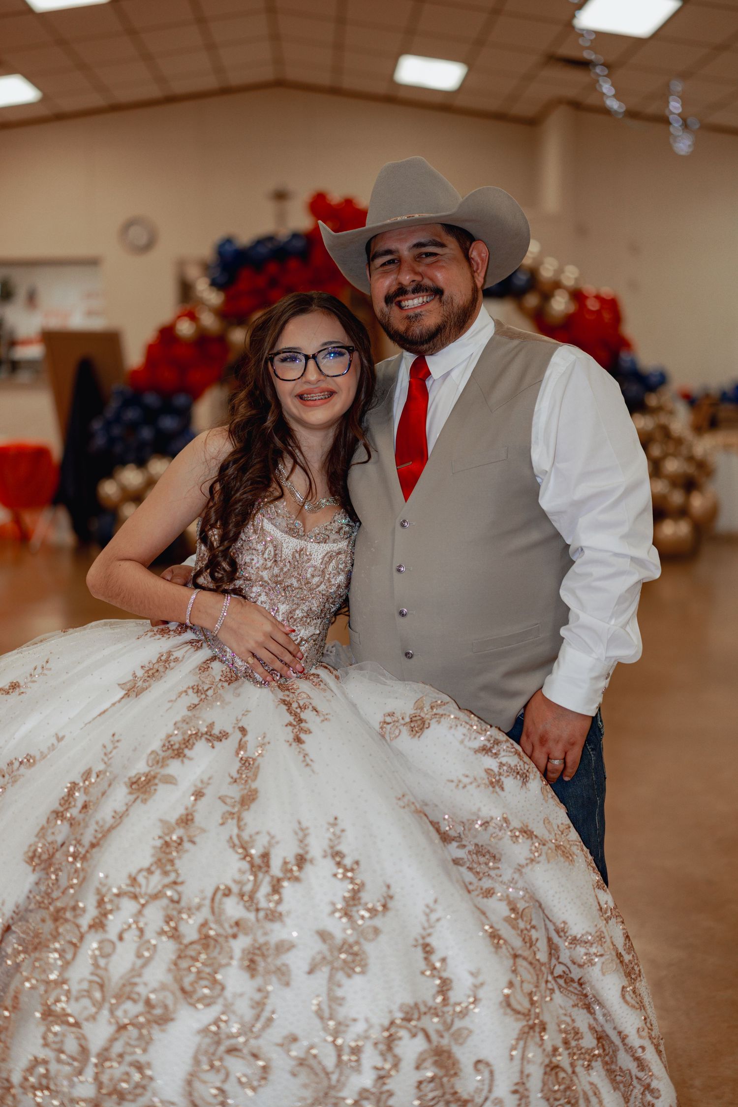 Formal event with western attire and elaborate white ball gown.