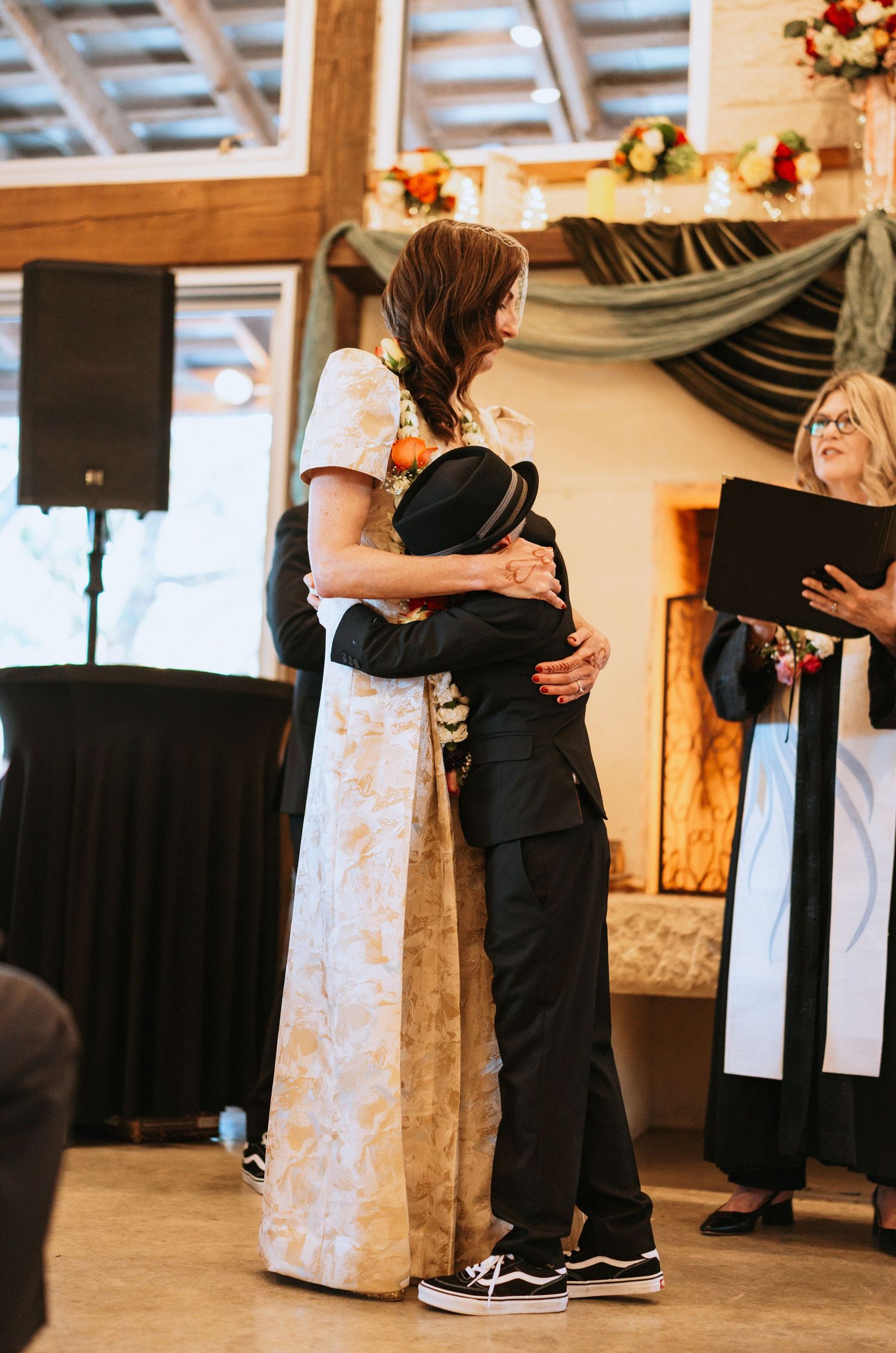 Couple dancing together at wedding reception with formal attire.