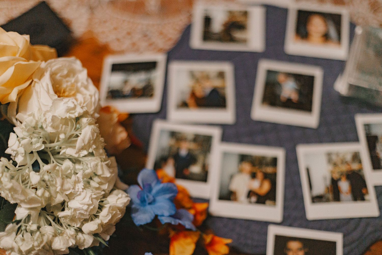 Wedding reception detail showing photo display wall with floral decorations.