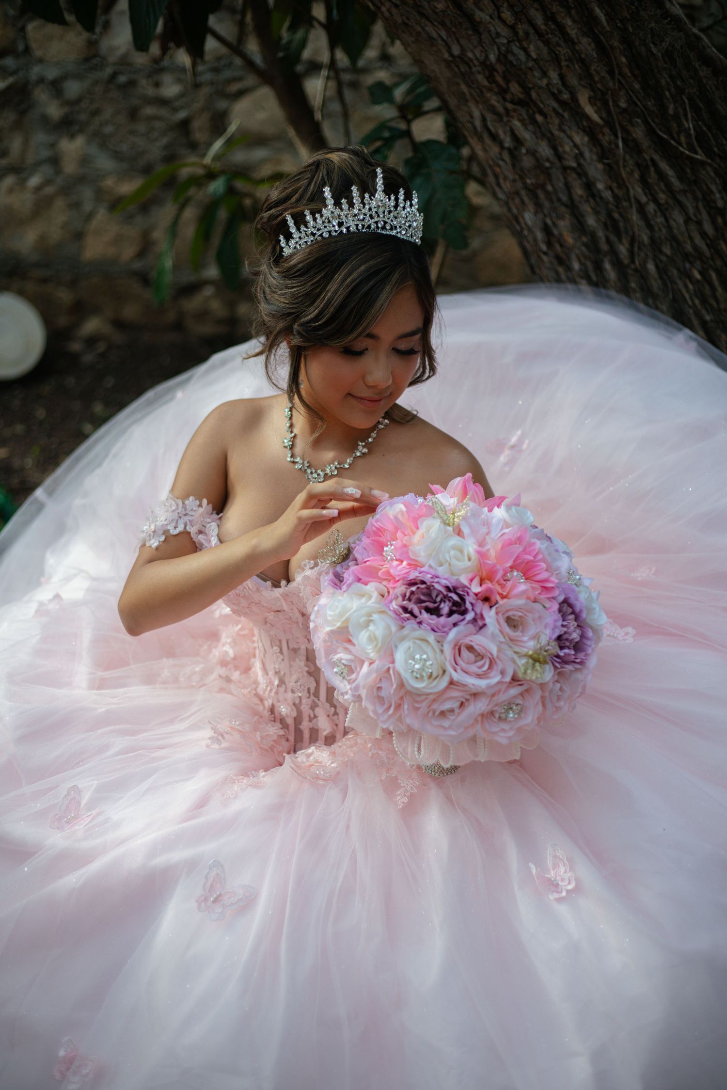 Overhead view of a pink and white princess ballgown with floral embellishments.