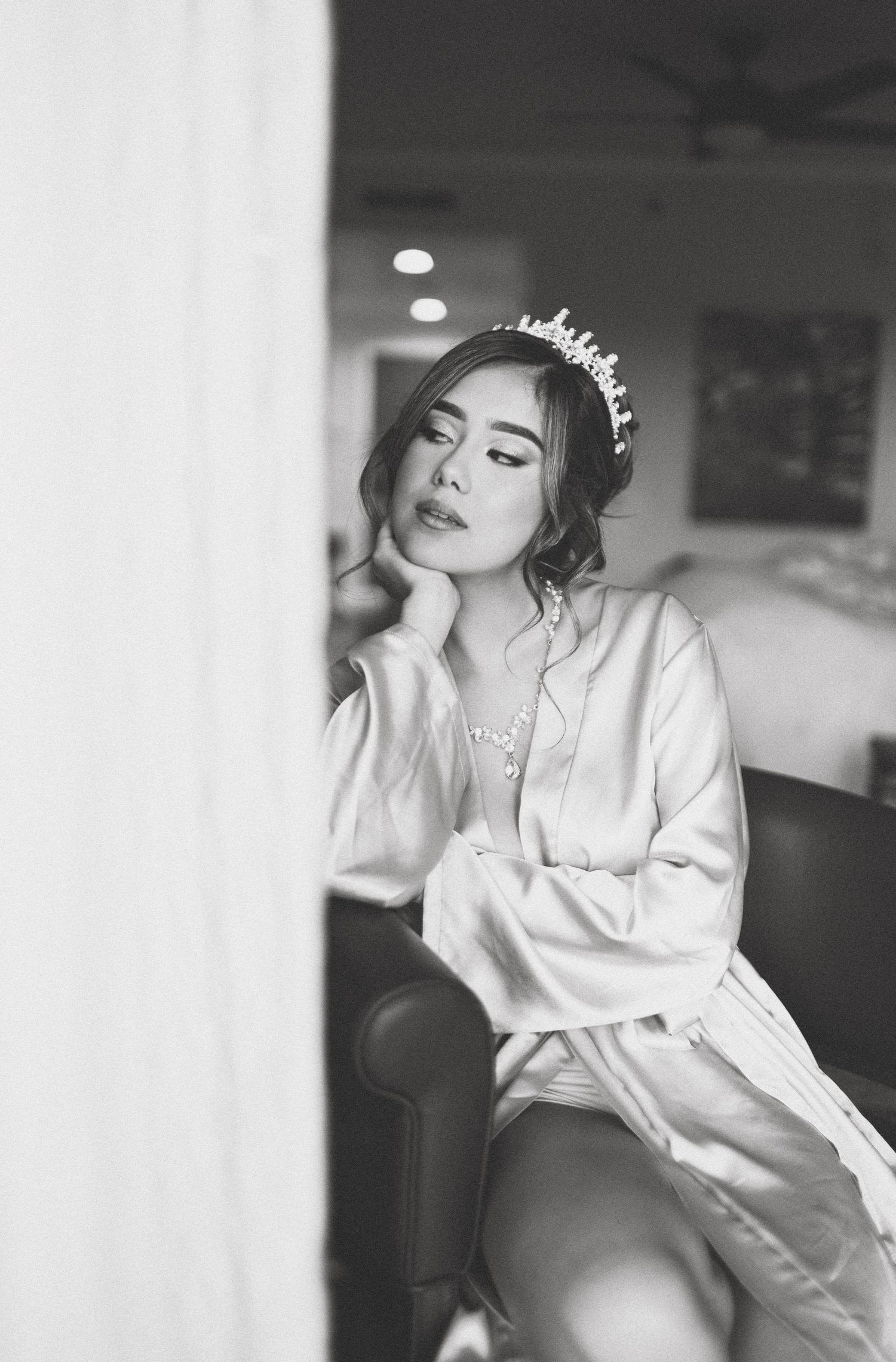 Artistic black and white boudoir photography with soft window lighting.