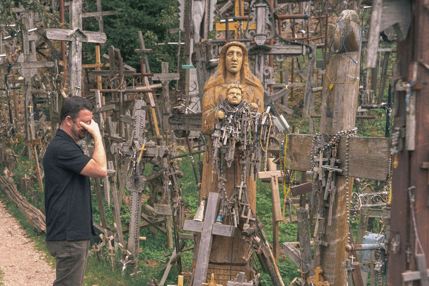Religious crosses and icons displayed at the Hill of Crosses pilgrimage site in Lithuania.
