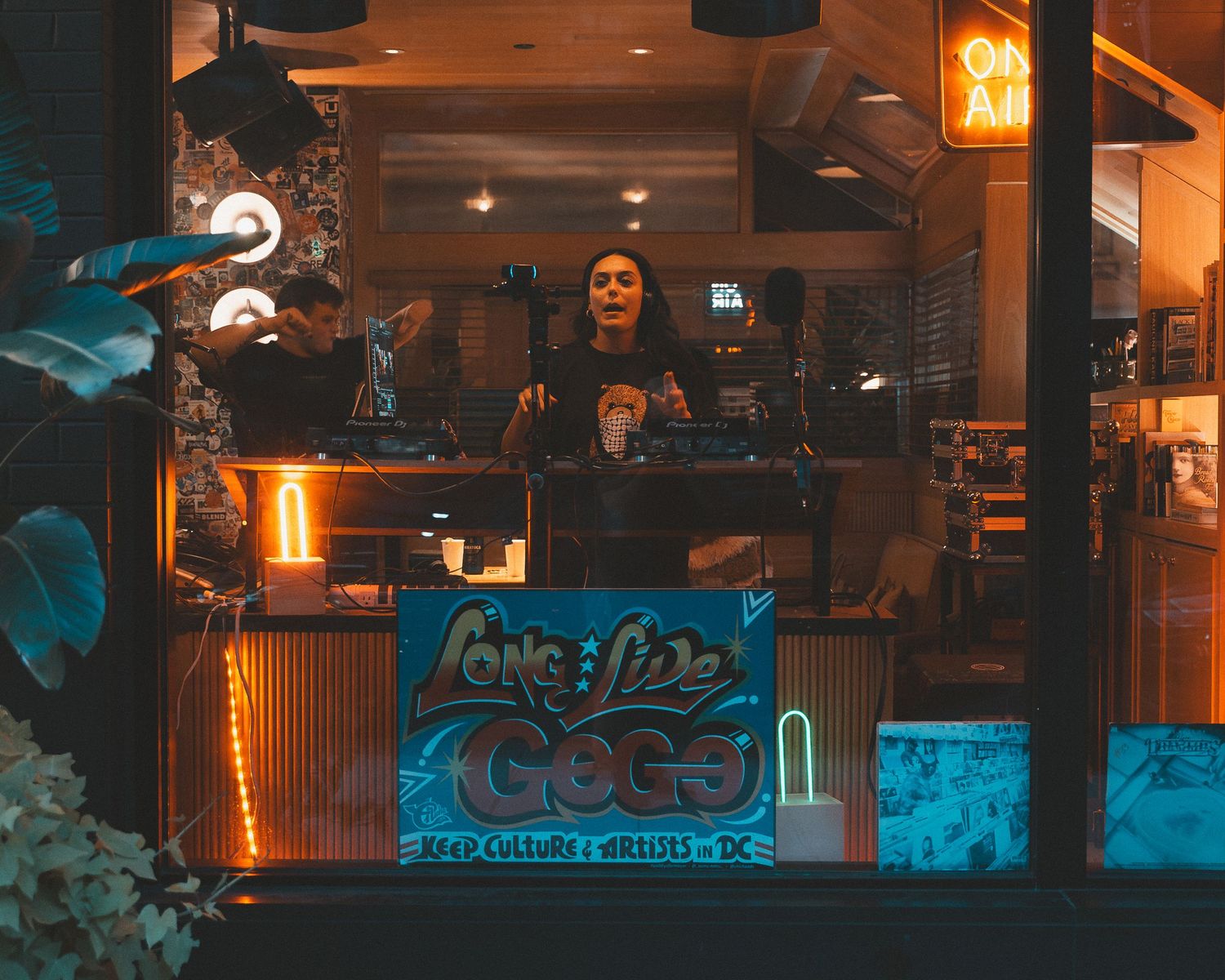 Modern bar interior with warm orange lighting and industrial design elements.