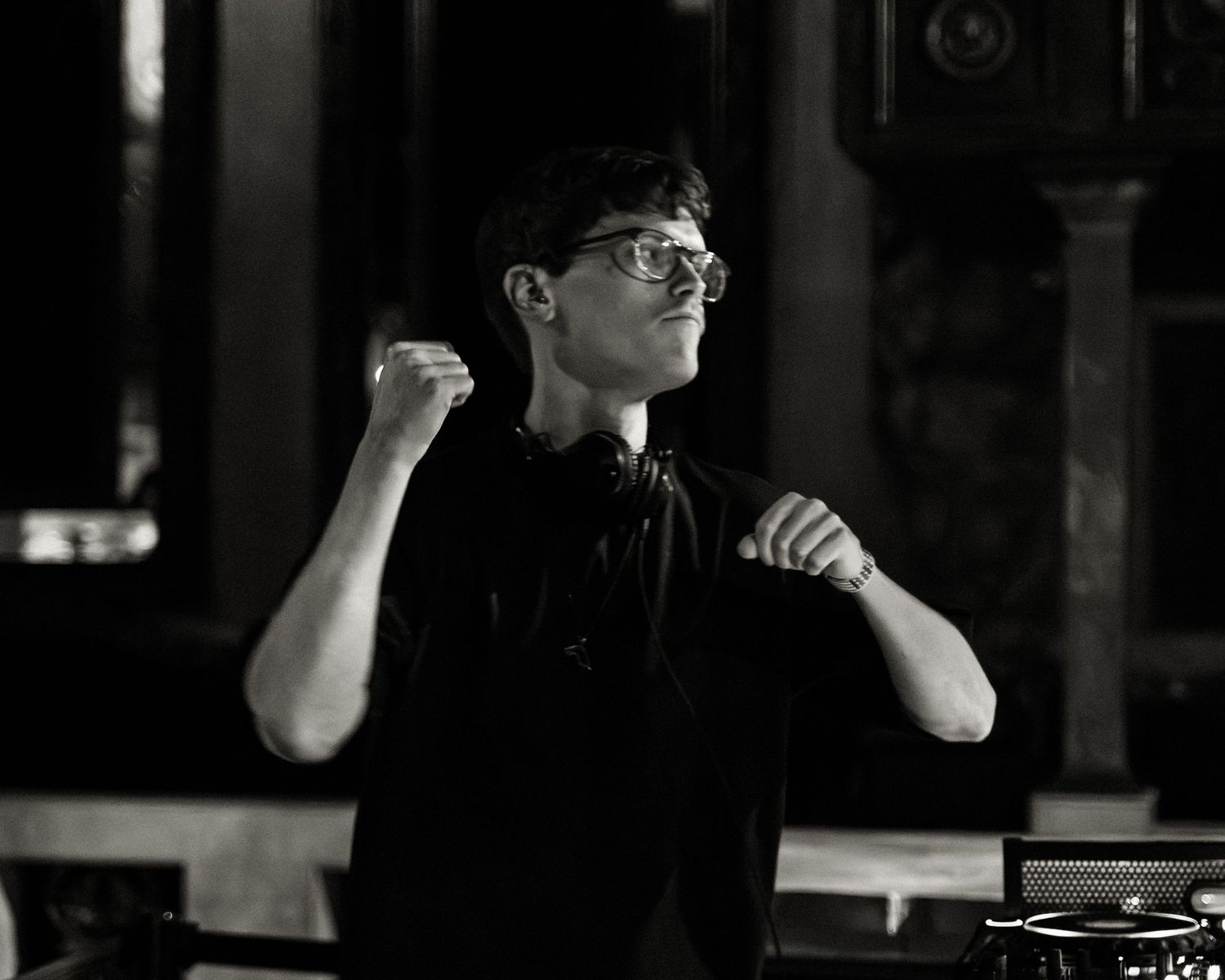 Dark moody performance shots captured in black and white at a nightclub.