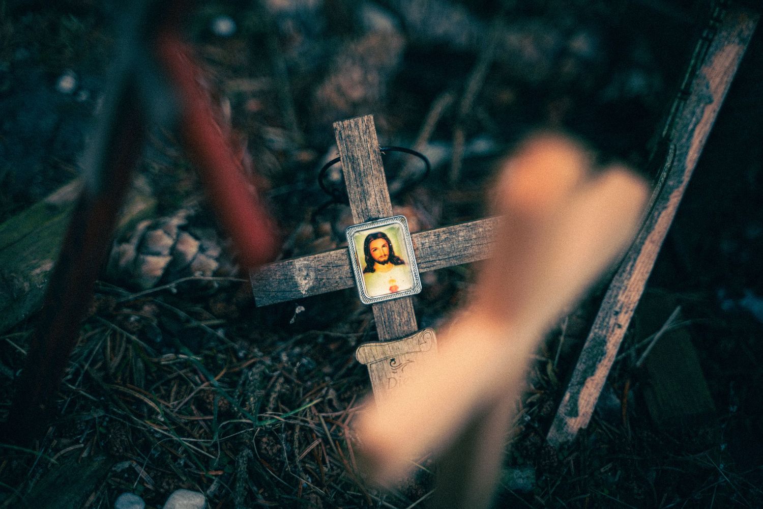Dark moody scene of religious crosses and icons at dusk.