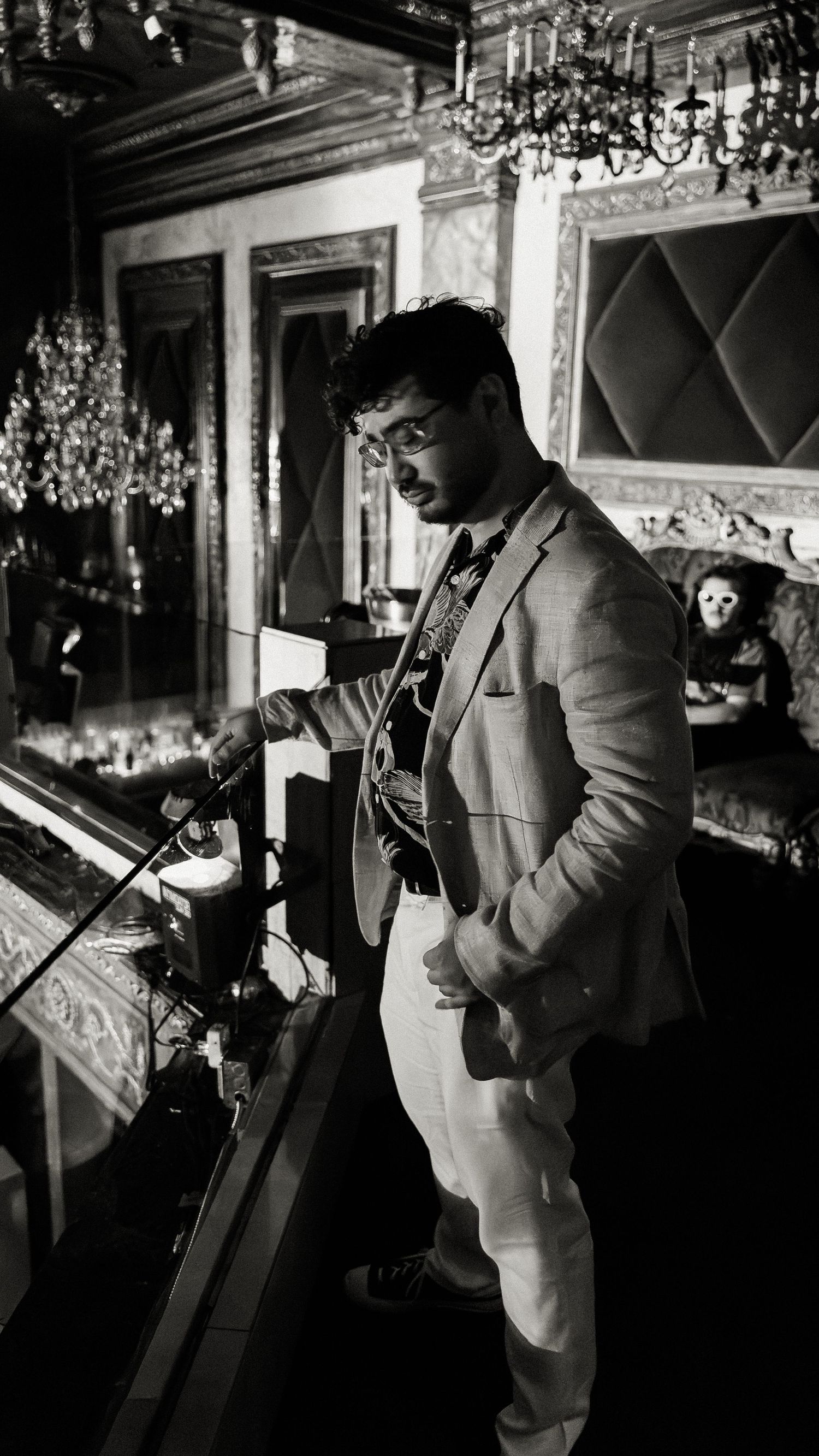 Musician performing in formal attire under dramatic stage lighting.