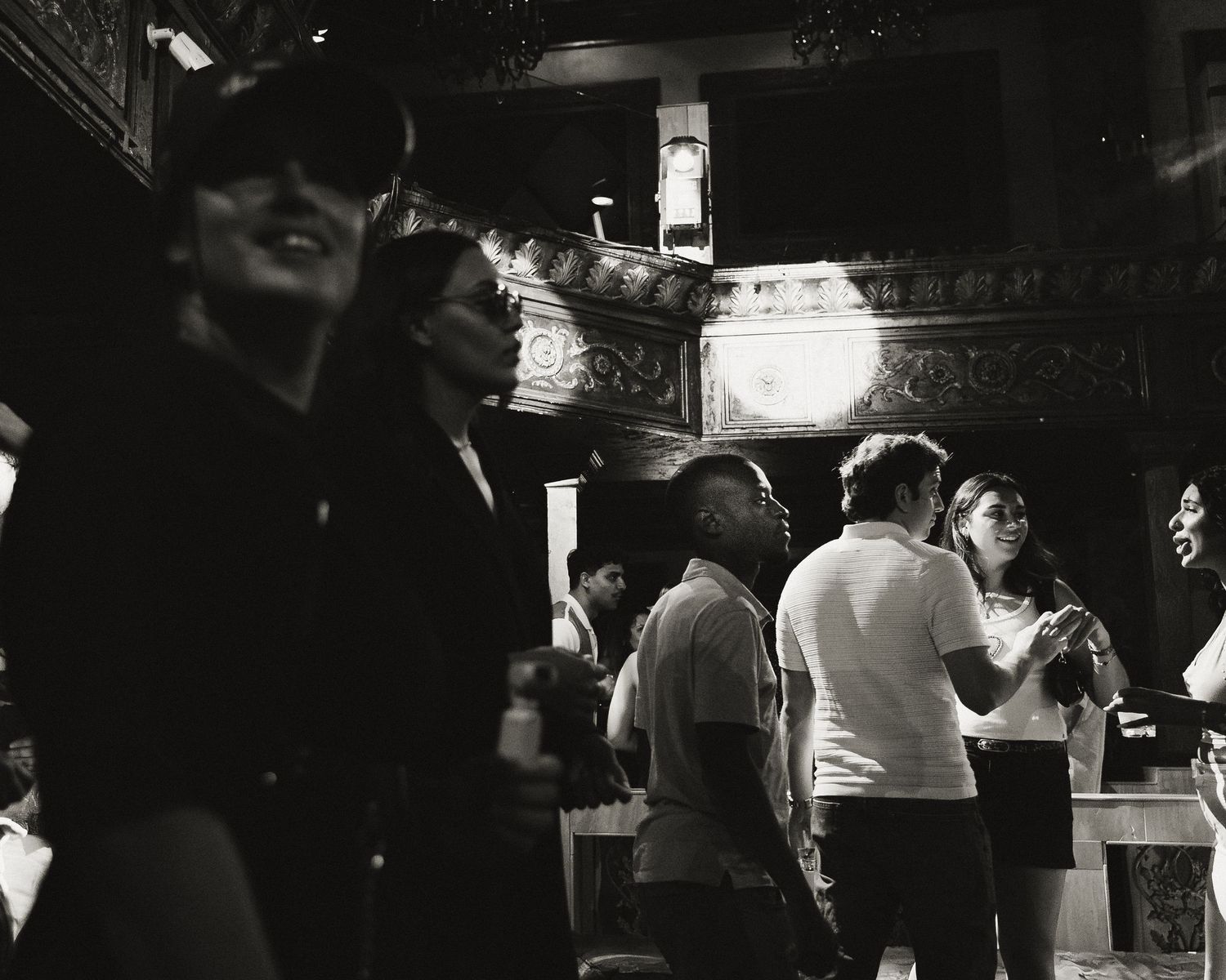People gathered in a dark entertainment venue with ambient lighting.