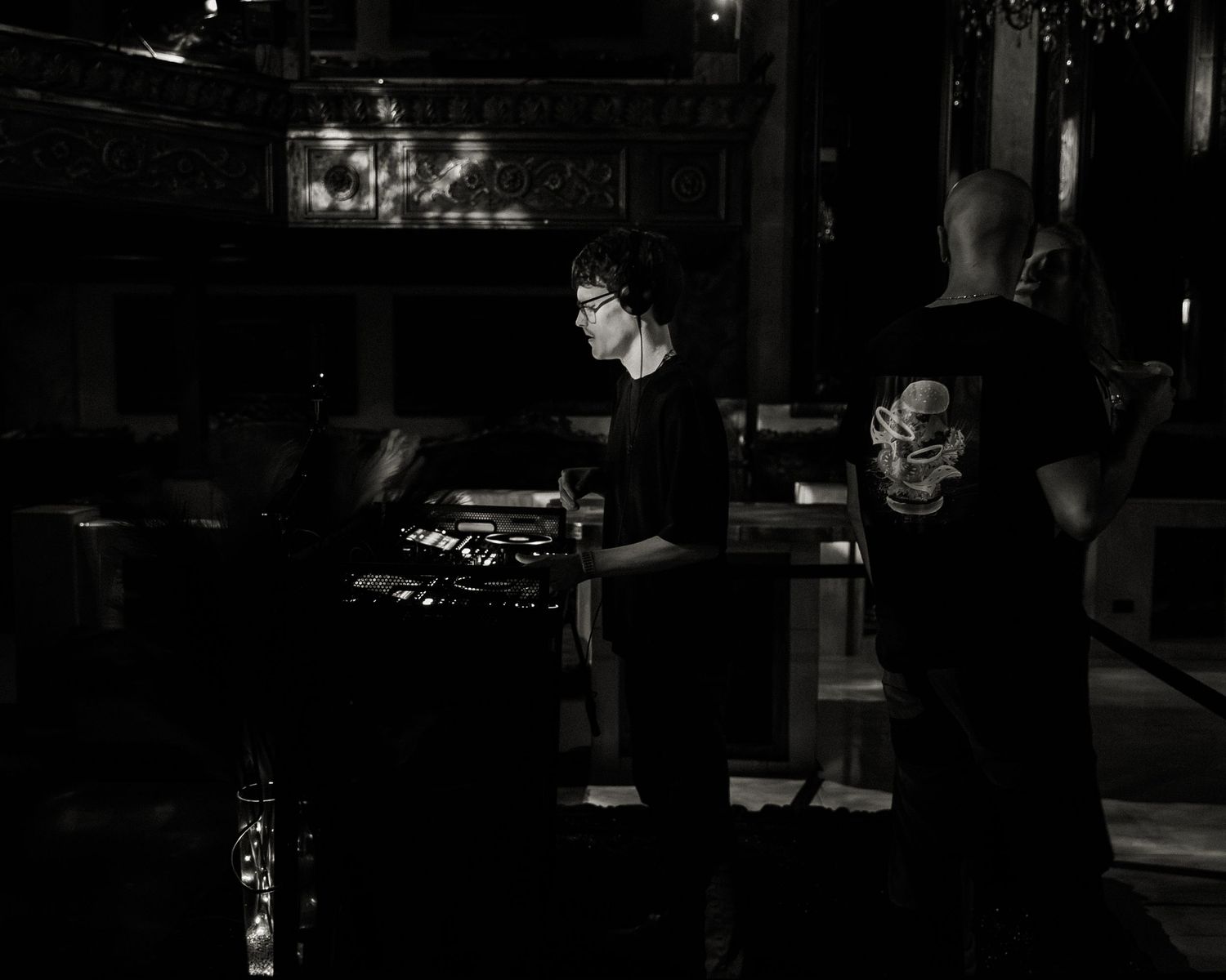 Dimly lit performance venue captured in a series of moody black and white shots.