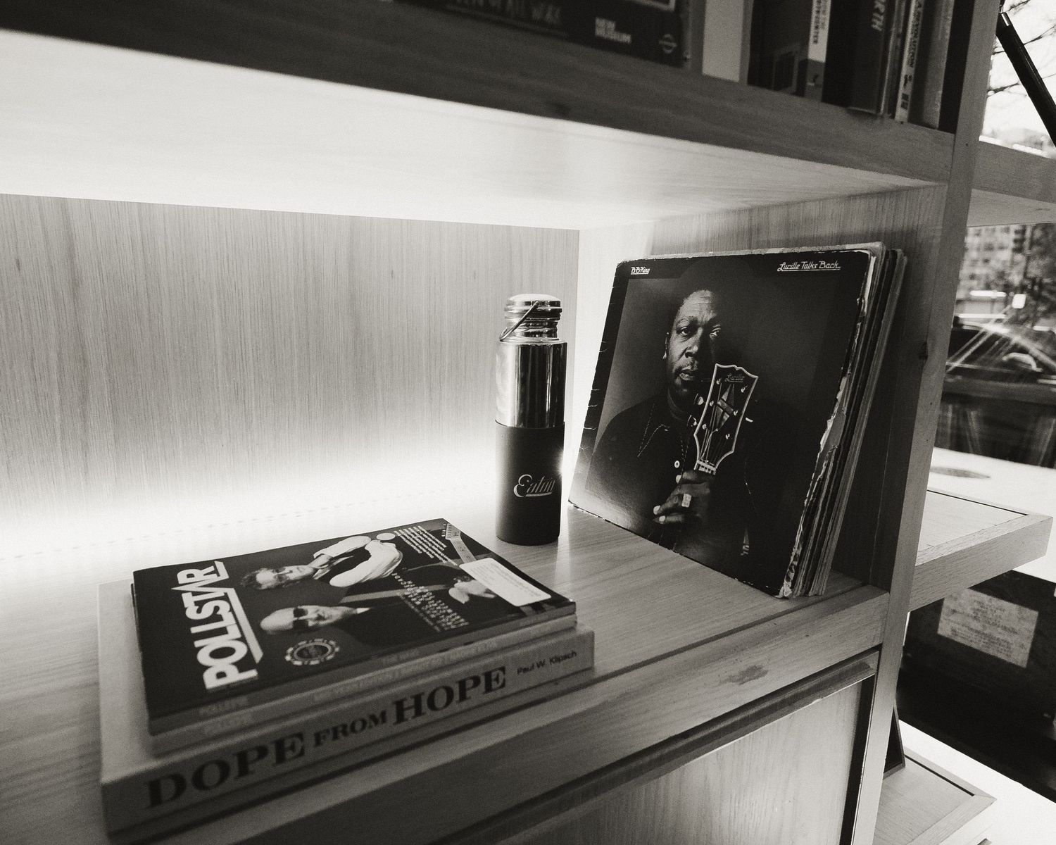 Black and white panoramic view of empty shelves in a minimalist retail display setting.