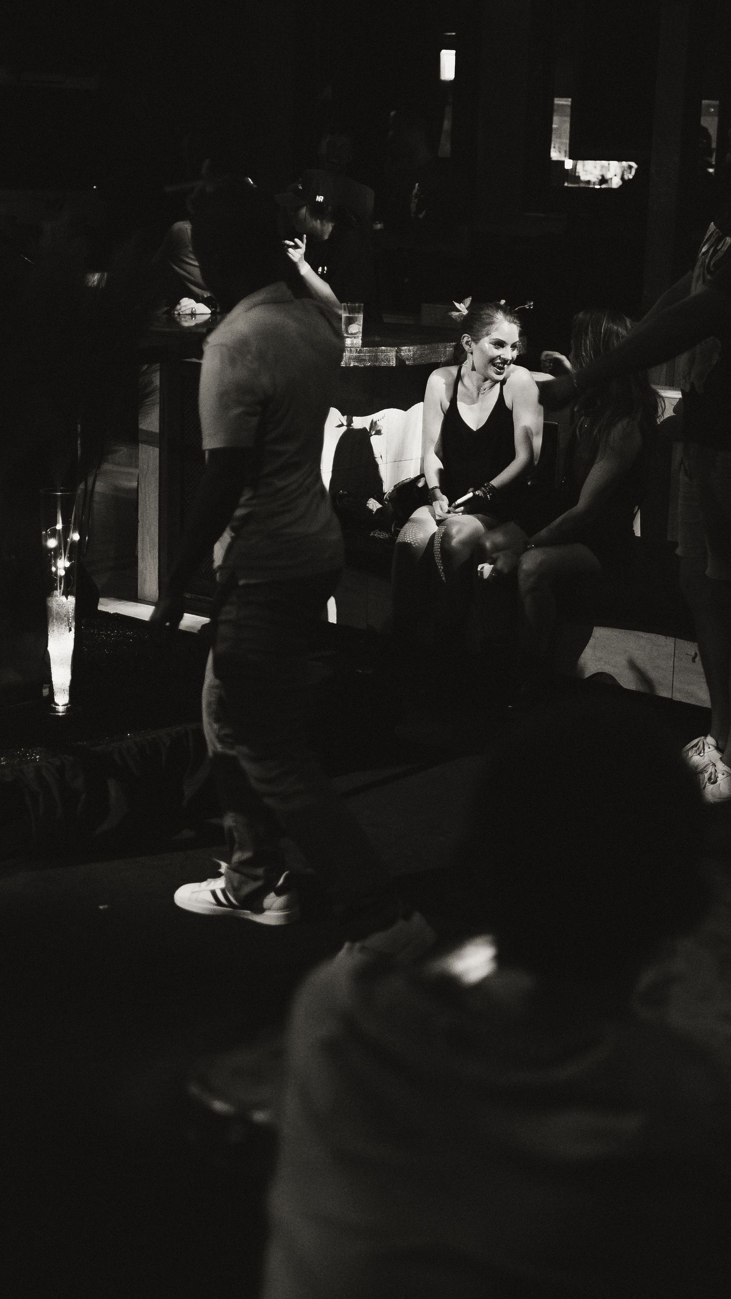 People gathered in a dimly lit nightclub atmosphere.