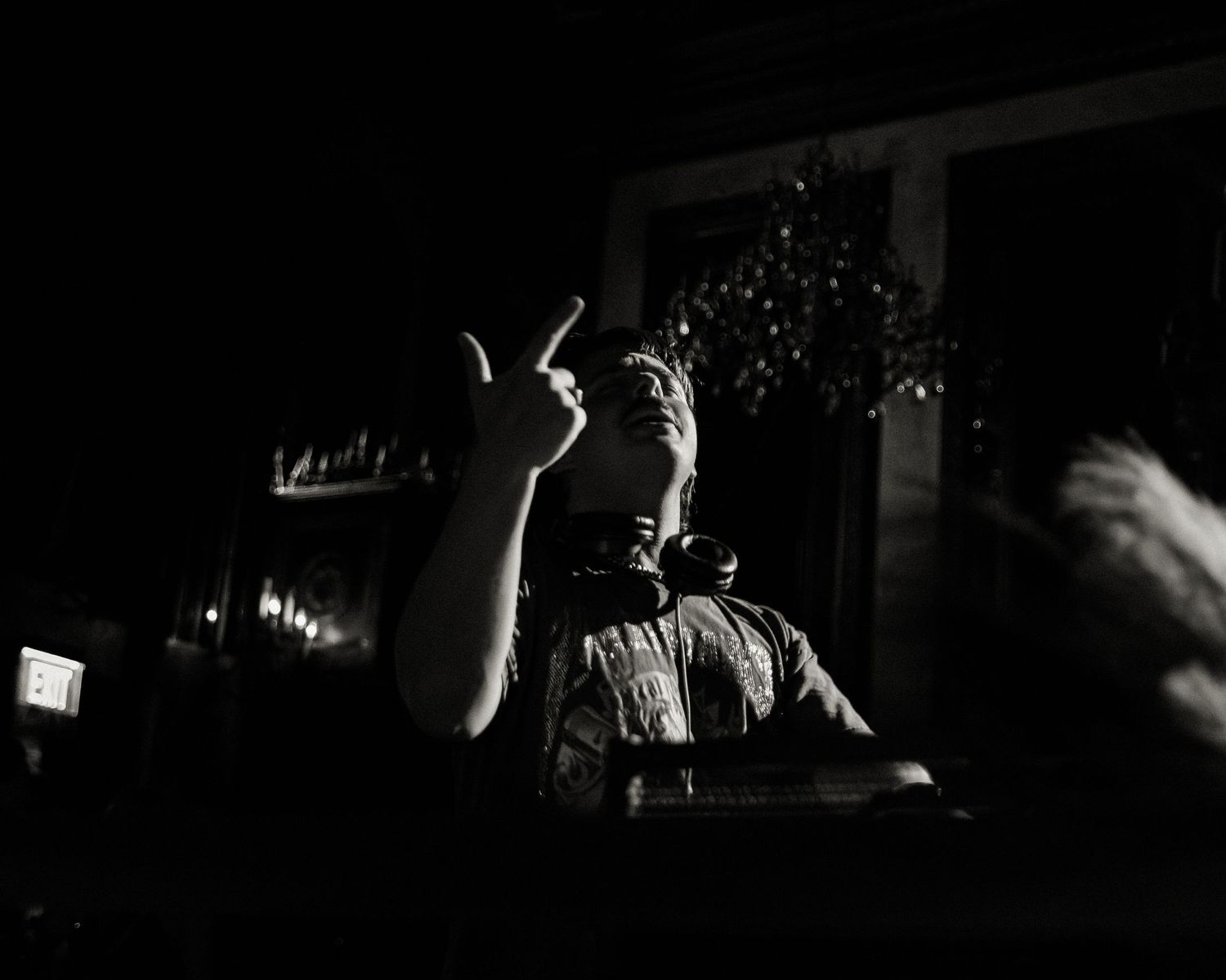 Silhouettes of people dancing in a dark nightclub atmosphere.