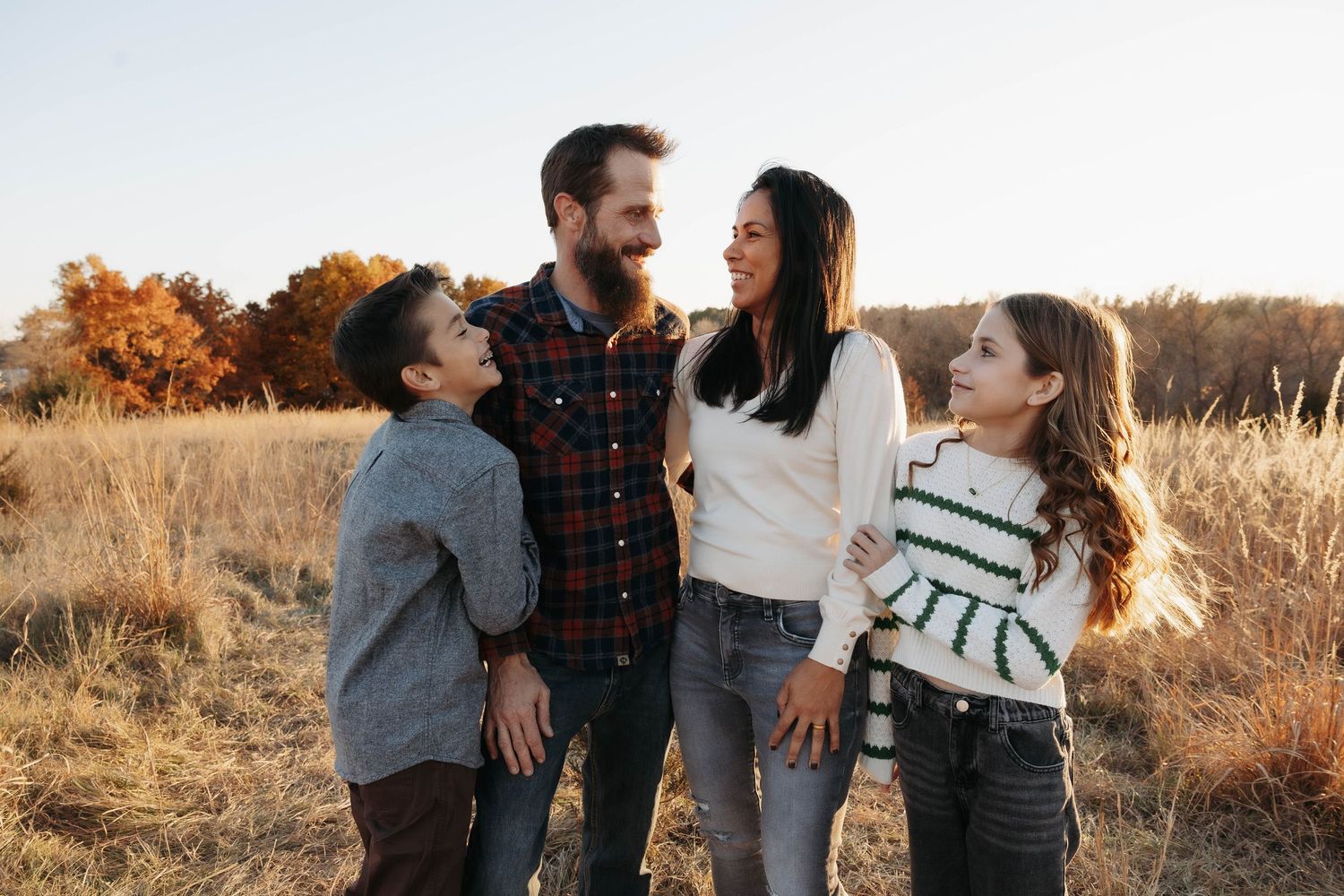 Family spending quality time together in an autumn field at sunset.