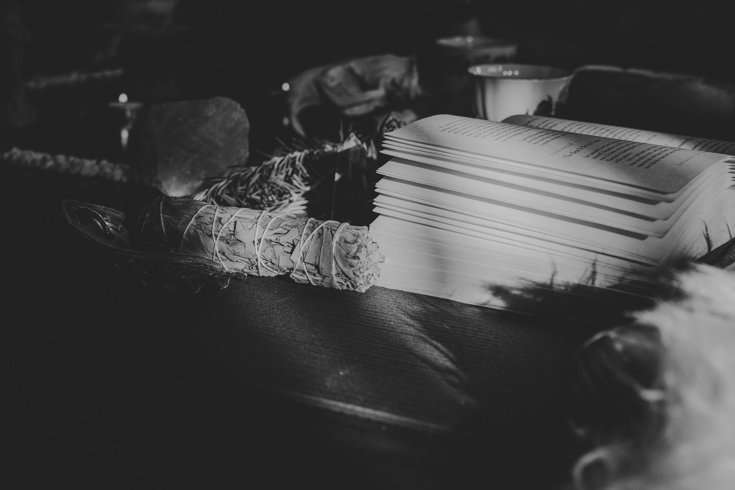 Black and white close-up of camera equipment and film strips in dark lighting.
