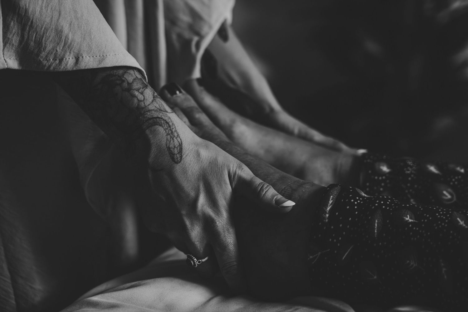 Close-up of weathered hands in dramatic lighting creating an atmospheric mood.