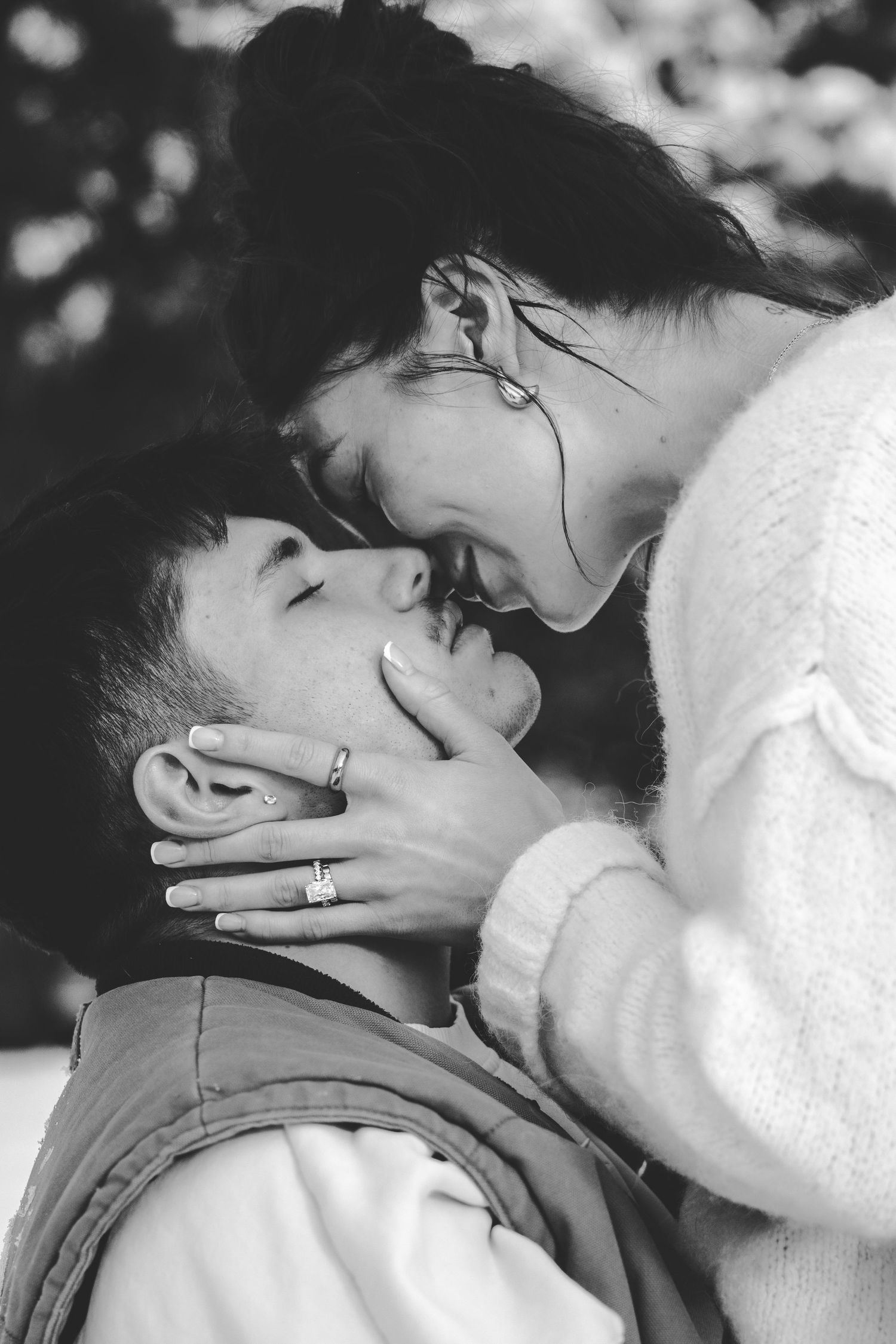 An intimate black and white portrait series showing tender moments between a couple.