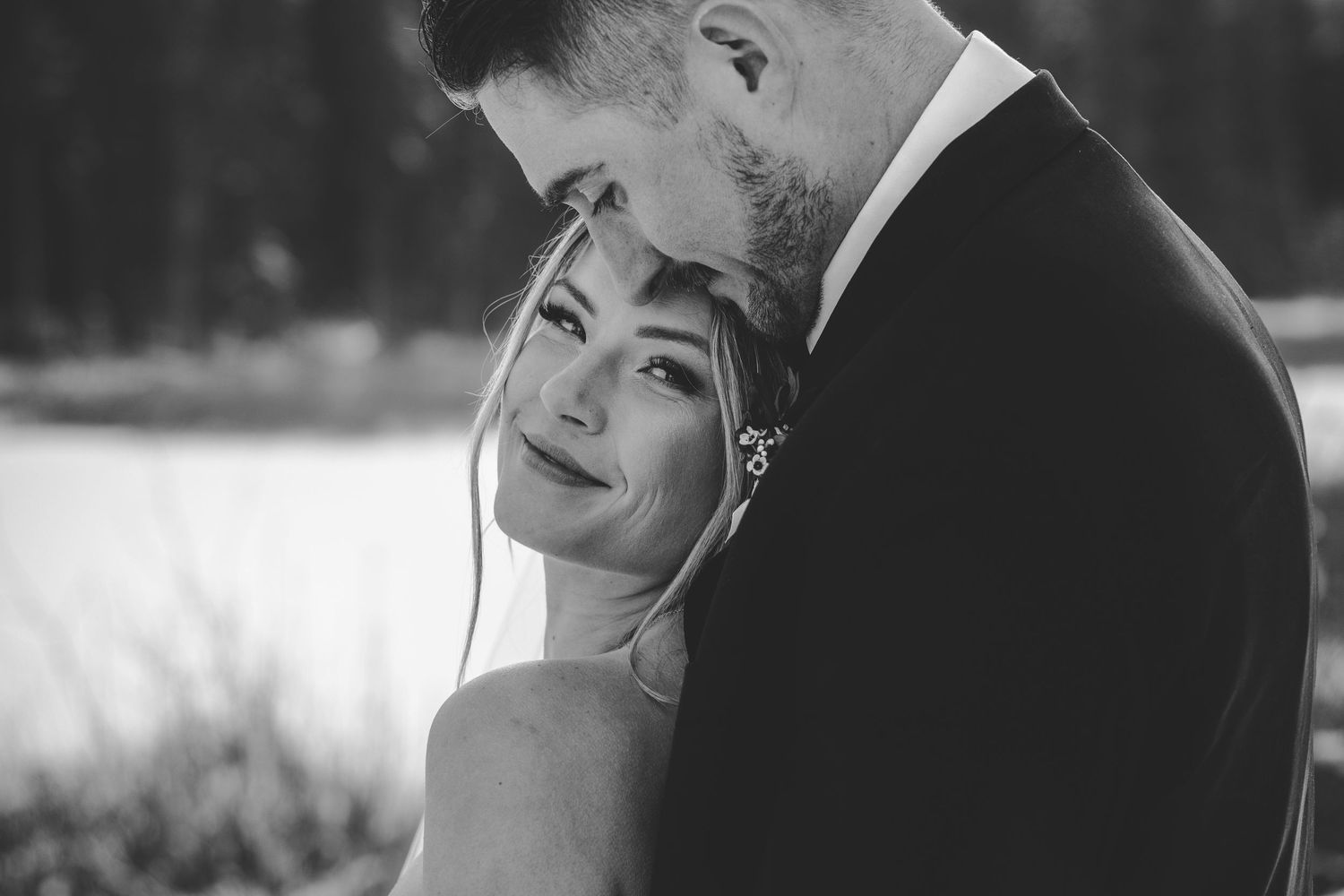 Black and white wedding portraits showing intimate moments between newlyweds.