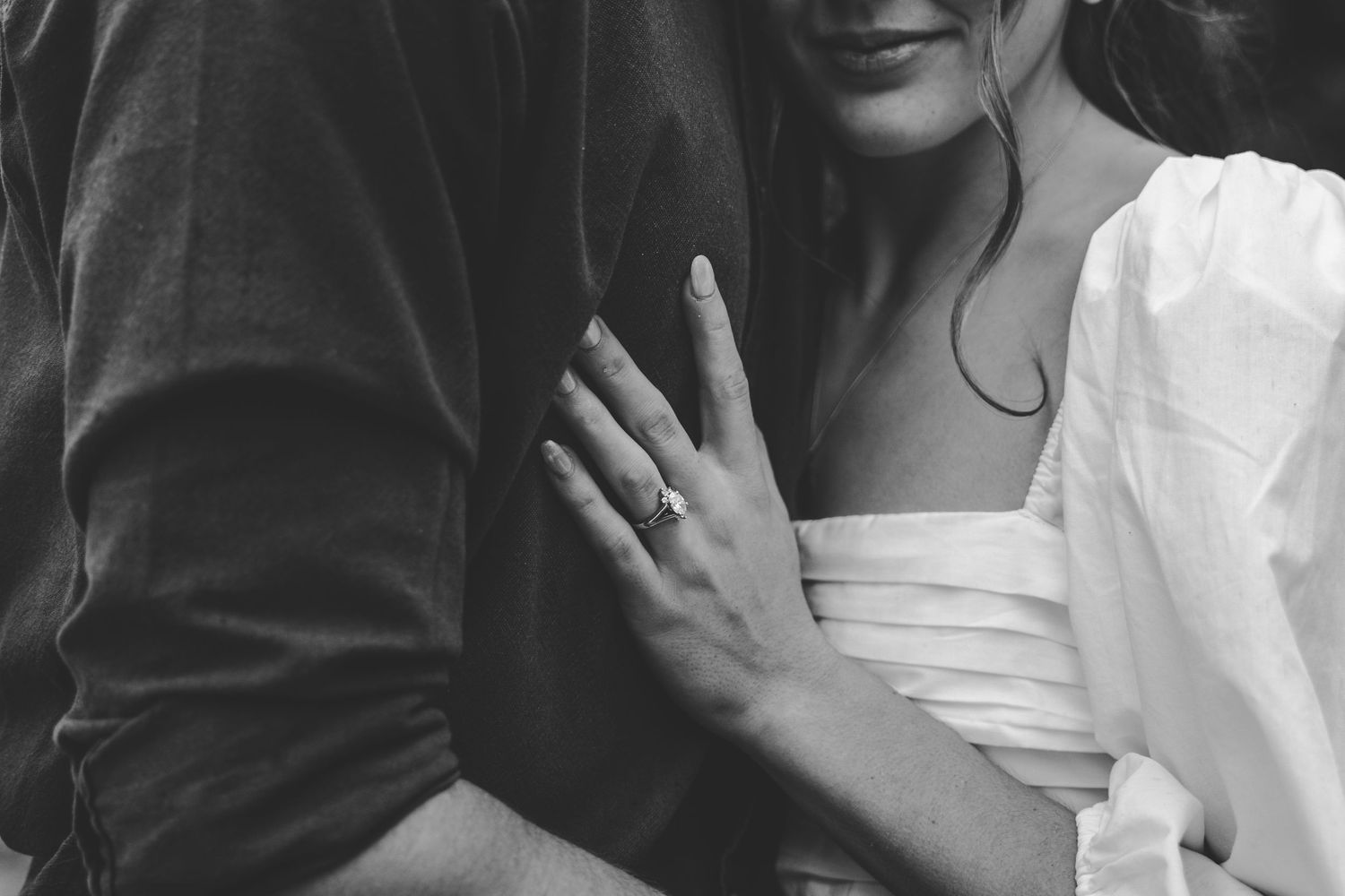 A tender black and white photograph capturing an intimate moment between two people.