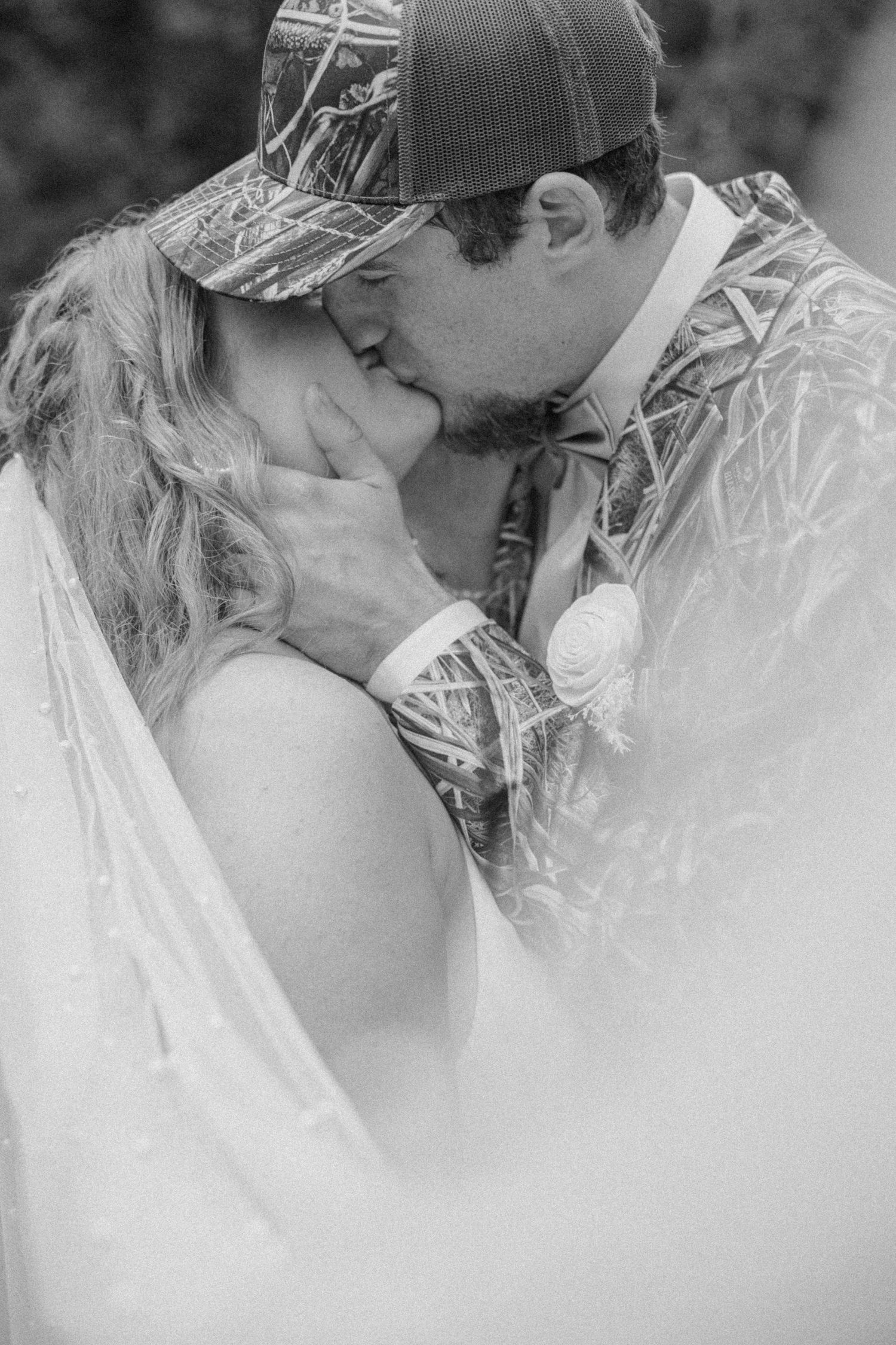 A romantic black and white photo sequence of a couple sharing an intimate kiss in a rustic outdoor setting.