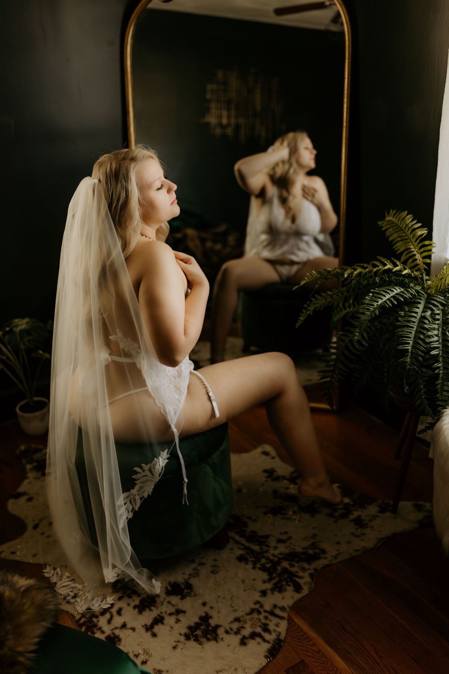 Intimate portrait session with dramatic lighting and botanical elements.