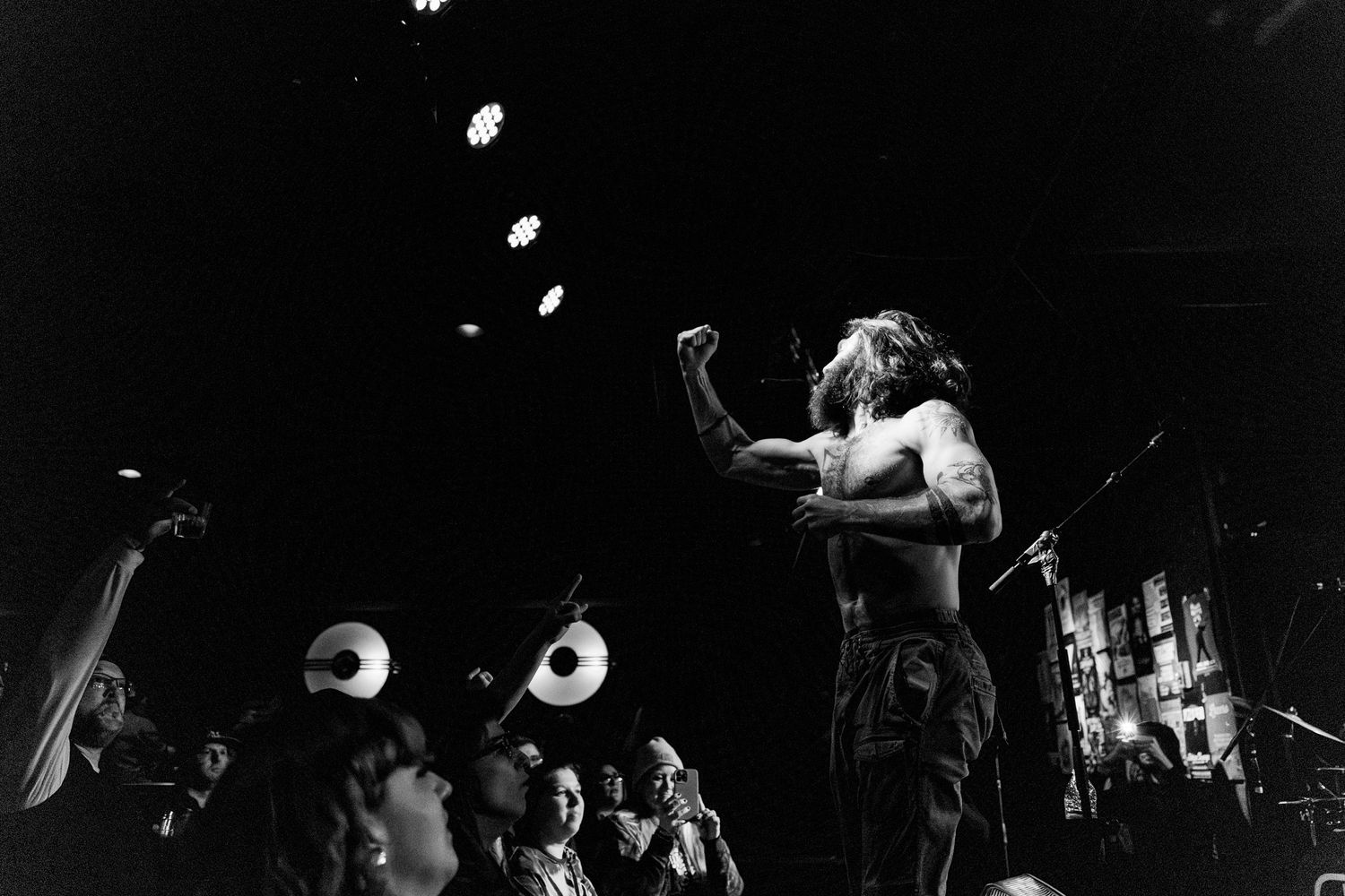 Black and white concert photo showing energetic stage performance.