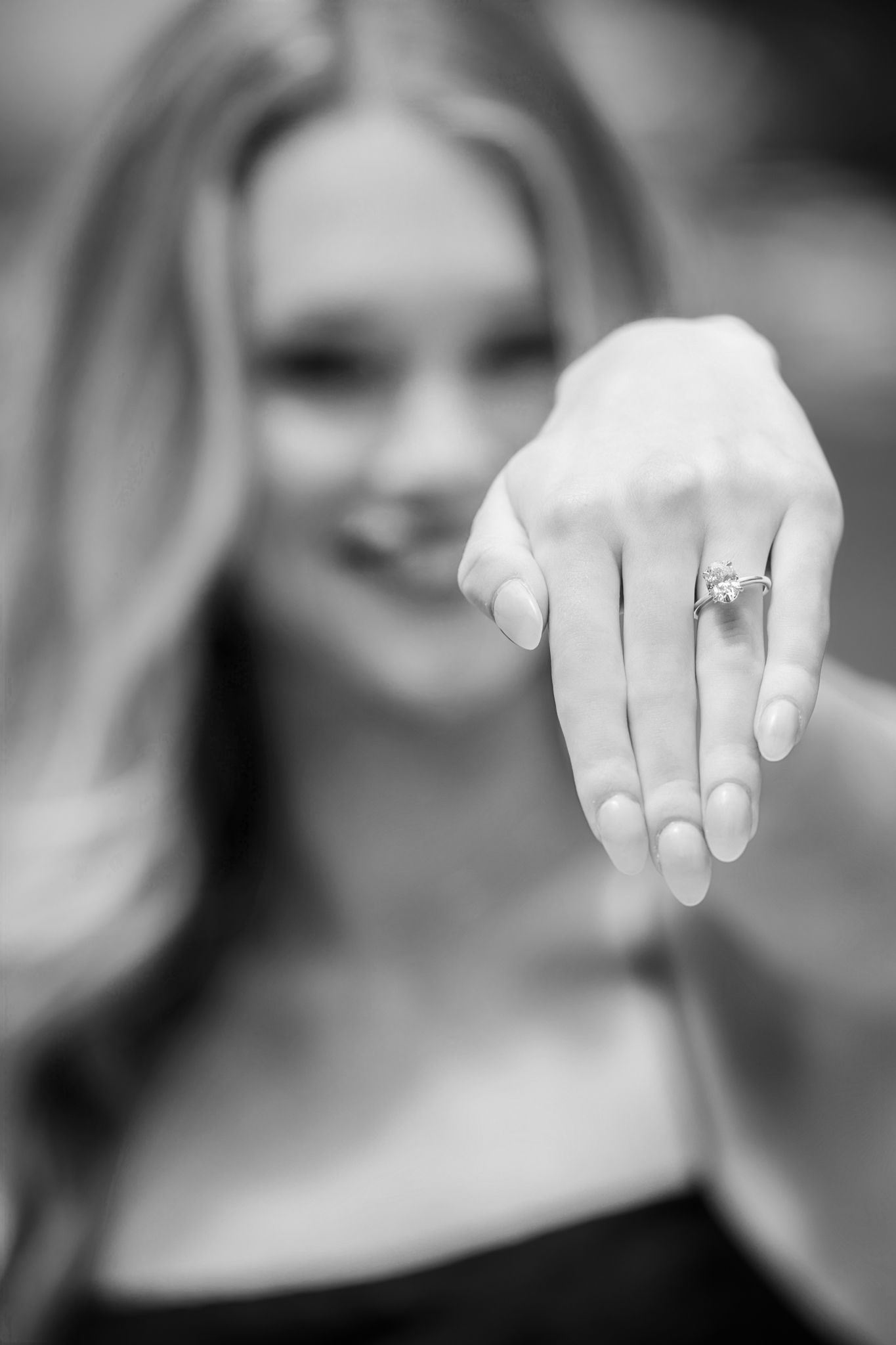 Close-up series showing hands displaying an engagement ring.