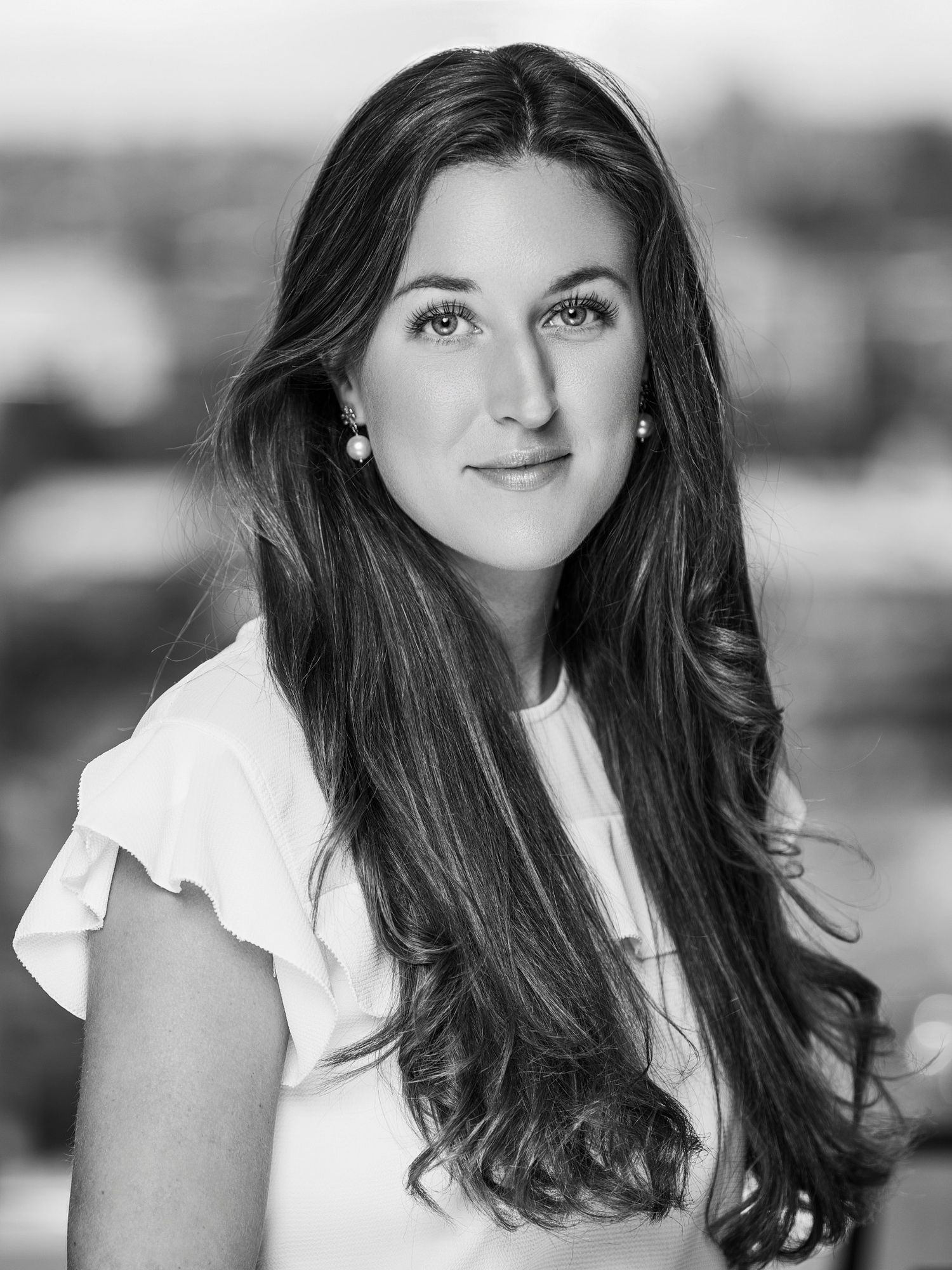 Classic black and white headshots with soft lighting and natural expressions.