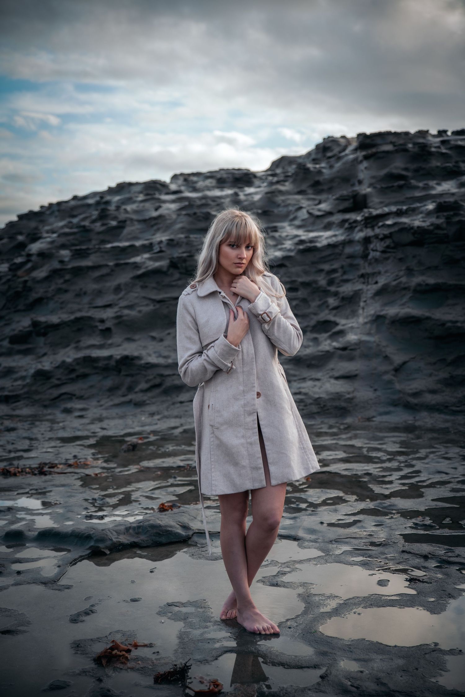 Atmospheric photos on rocky beach with overcast sky and dramatic lighting.