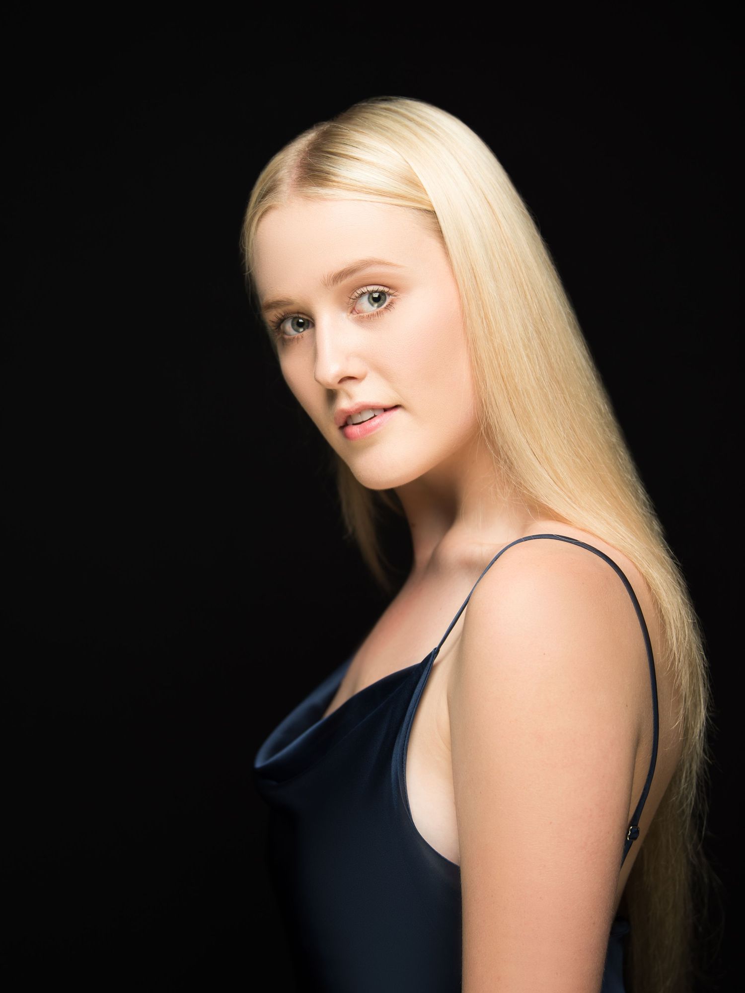 Portrait series against dark background highlighting blonde hair and natural lighting.