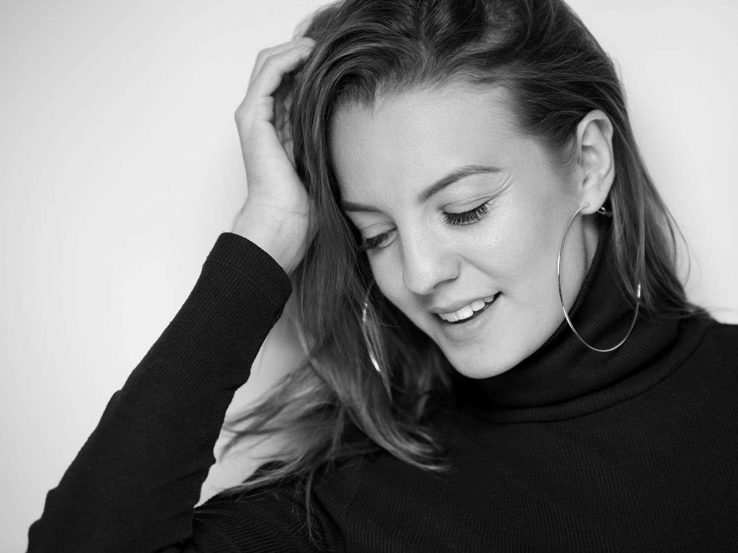 Black and white studio portraits featuring elegant poses and expressions.