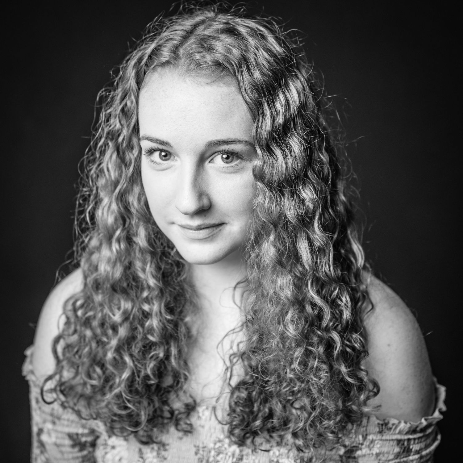 Black and white portraits showcasing natural curly hair and expressive poses.
