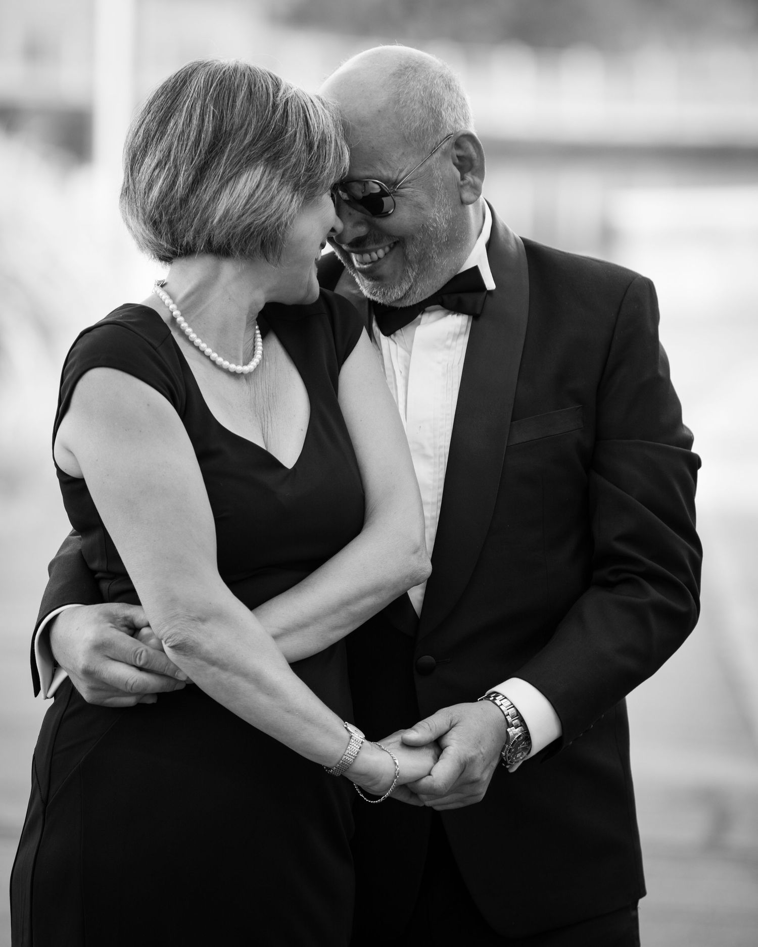 Elegant black and white portraits showing intimate embraces in formal attire.