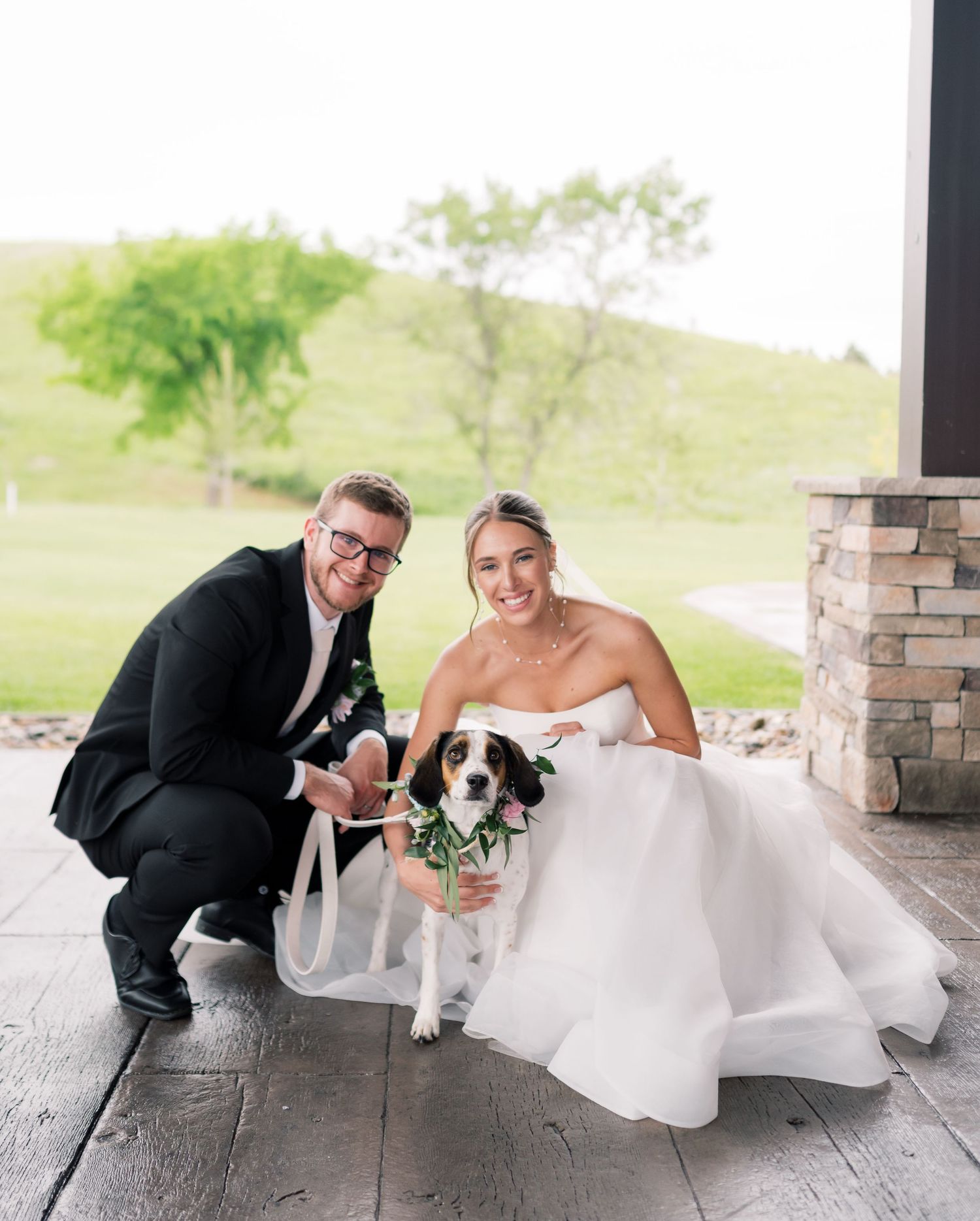 A couple and their dog pose playfully on the ground in a sequence of wedding photos on a covered porch.