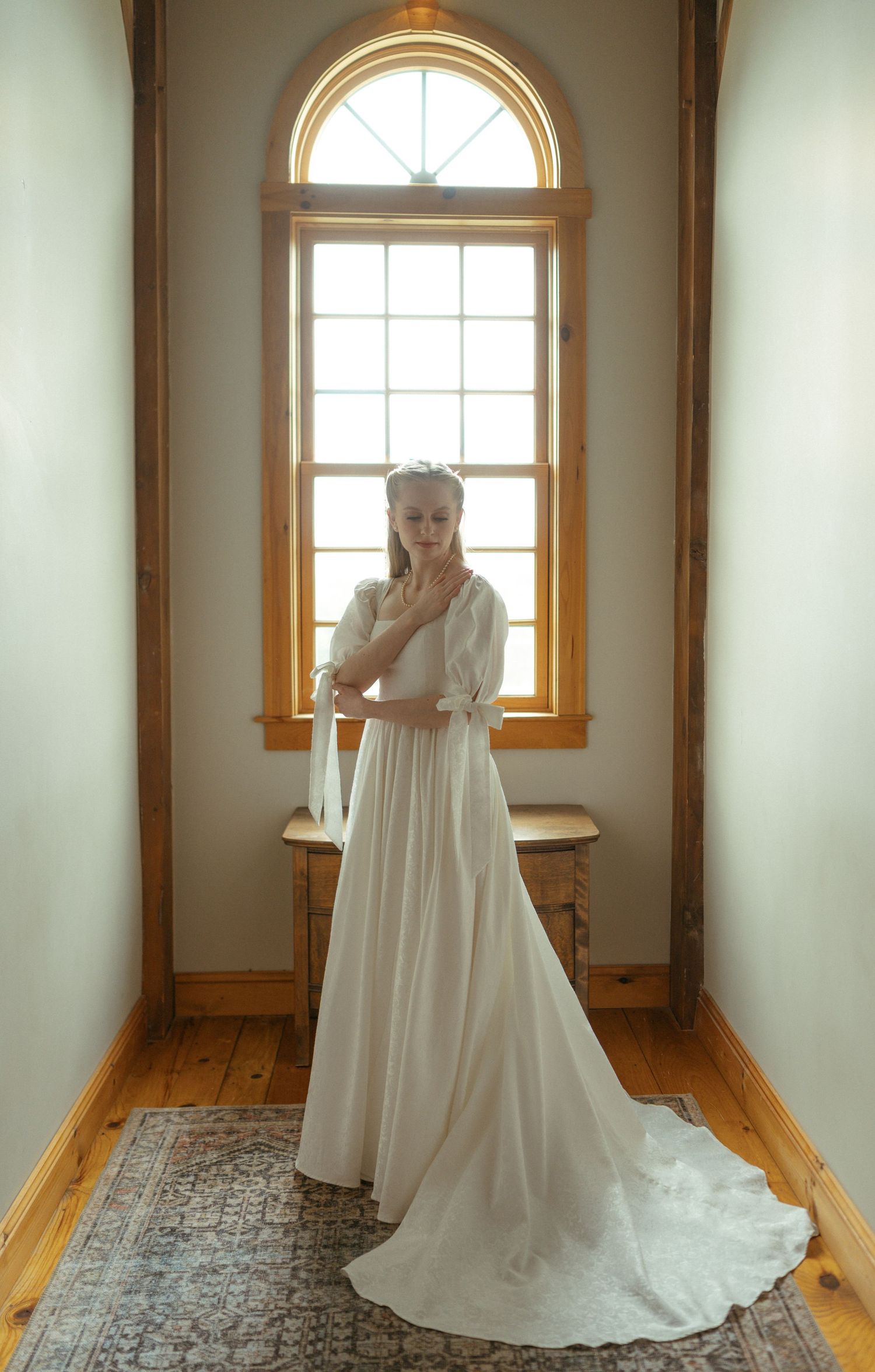 Four sequential photos show a figure in a flowing white wedding dress standing in a sunlit room with arched windows.