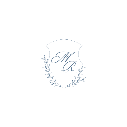 Elegant monogram logo design with delicate floral wreath and decorative swirls in light blue tones.