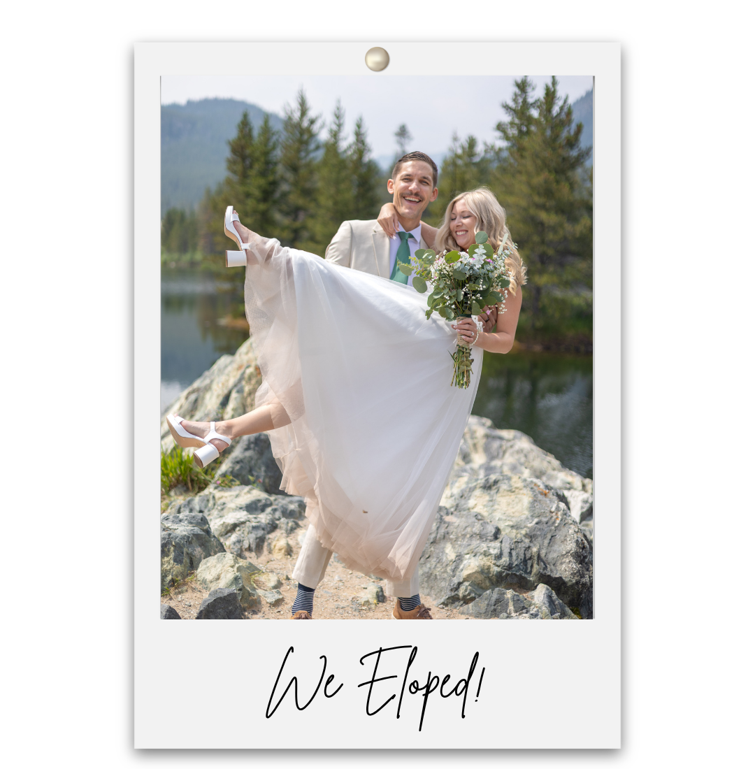 A groom lifts his bride in a white dress outdoors by a mountain lake, with text reading We Eloped below.