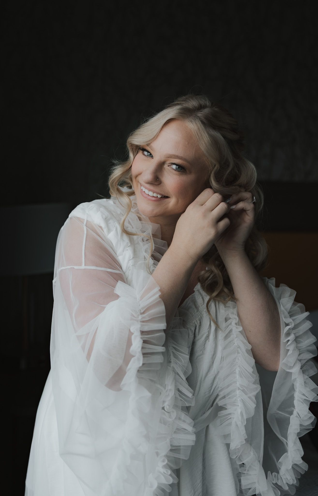 Artistic boudoir portraits featuring white ruffled fabric against dark background.