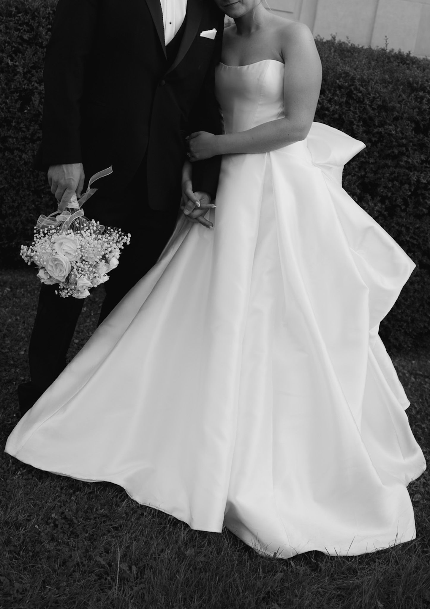 Close-up details of a flowing white wedding dress during intimate moments.