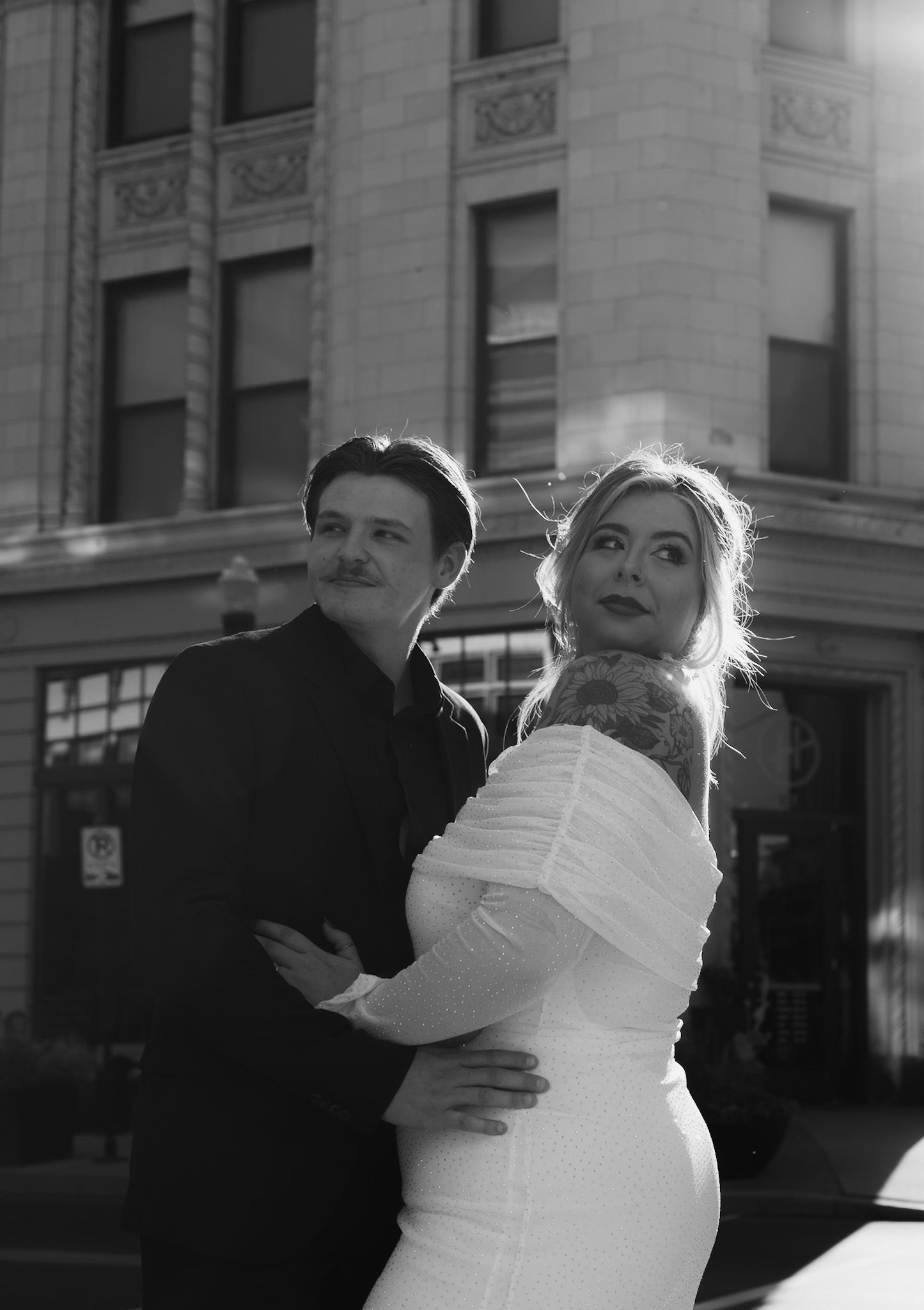 Series of black and white photos showing an intimate embrace between newlyweds.
