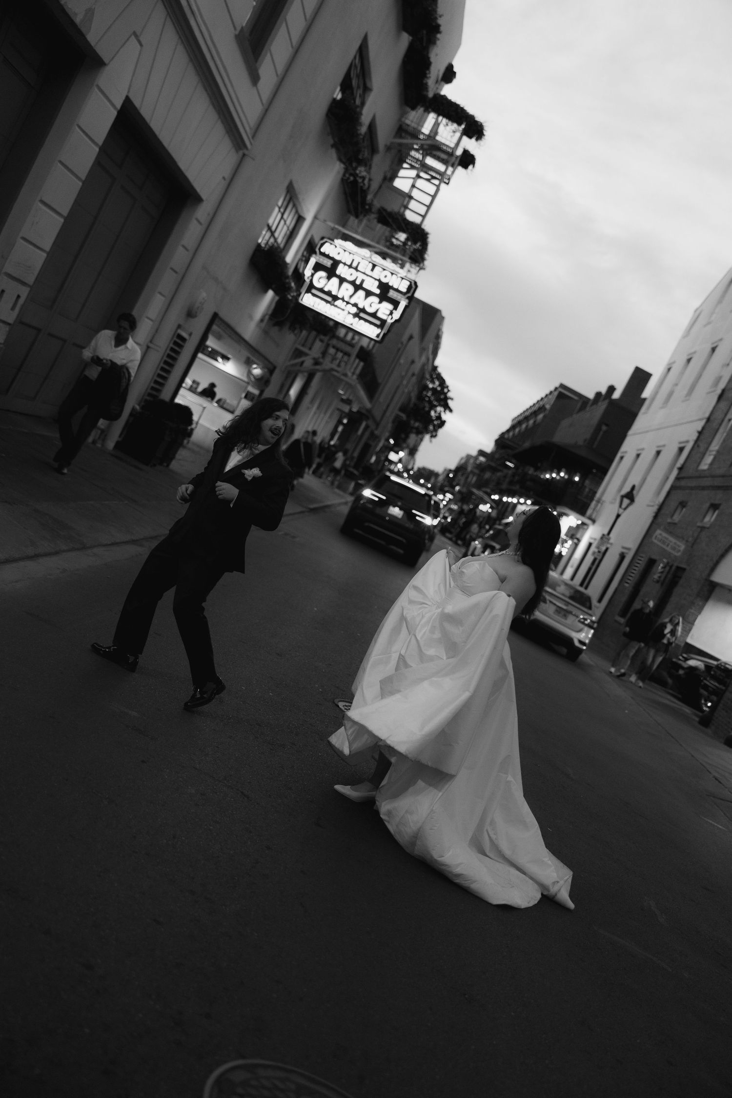 Black and white sequence of figures walking through an urban setting with dramatic angles.